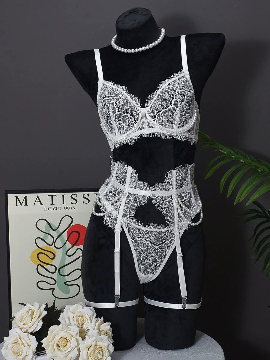 detail view of silver-tone metal garter clip and elastic leg garter band on white floral lace garter set