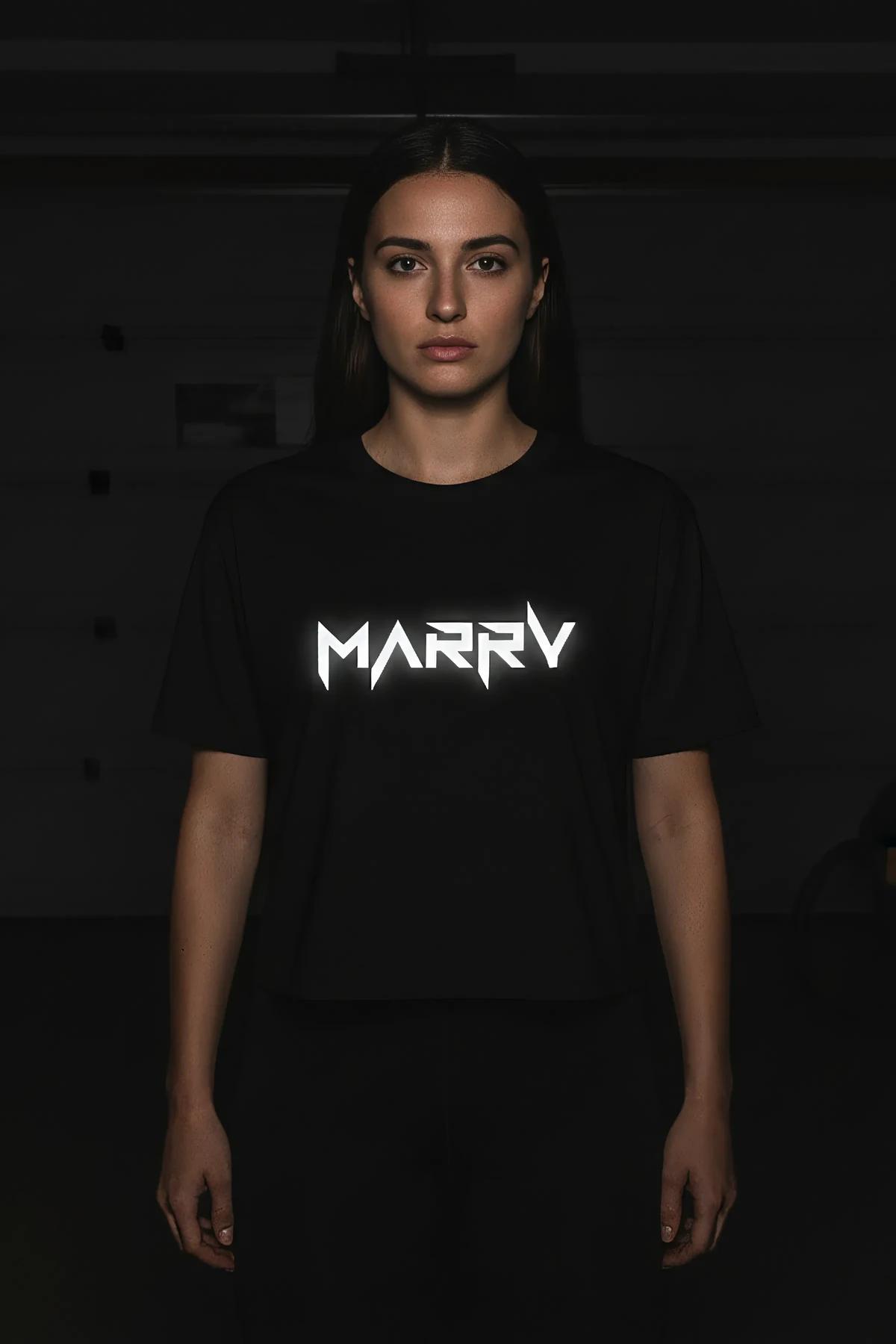 close-up of reflective heat-transfer text graphic on black cotton-jersey crop top glowing white