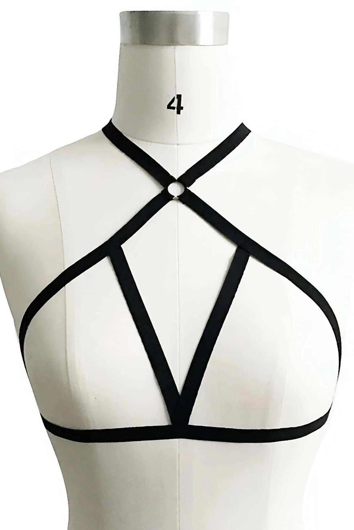 Close-up of gunmetal O-ring and crossing black elastic straps on chest harness