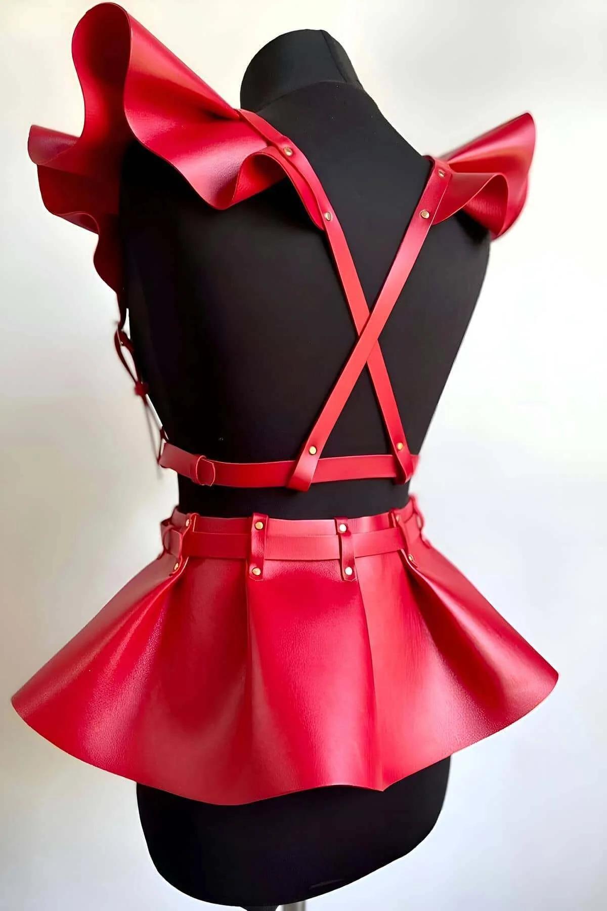 Close-up of red PU leather ruffled shoulder panels with gold rivet hardware detail