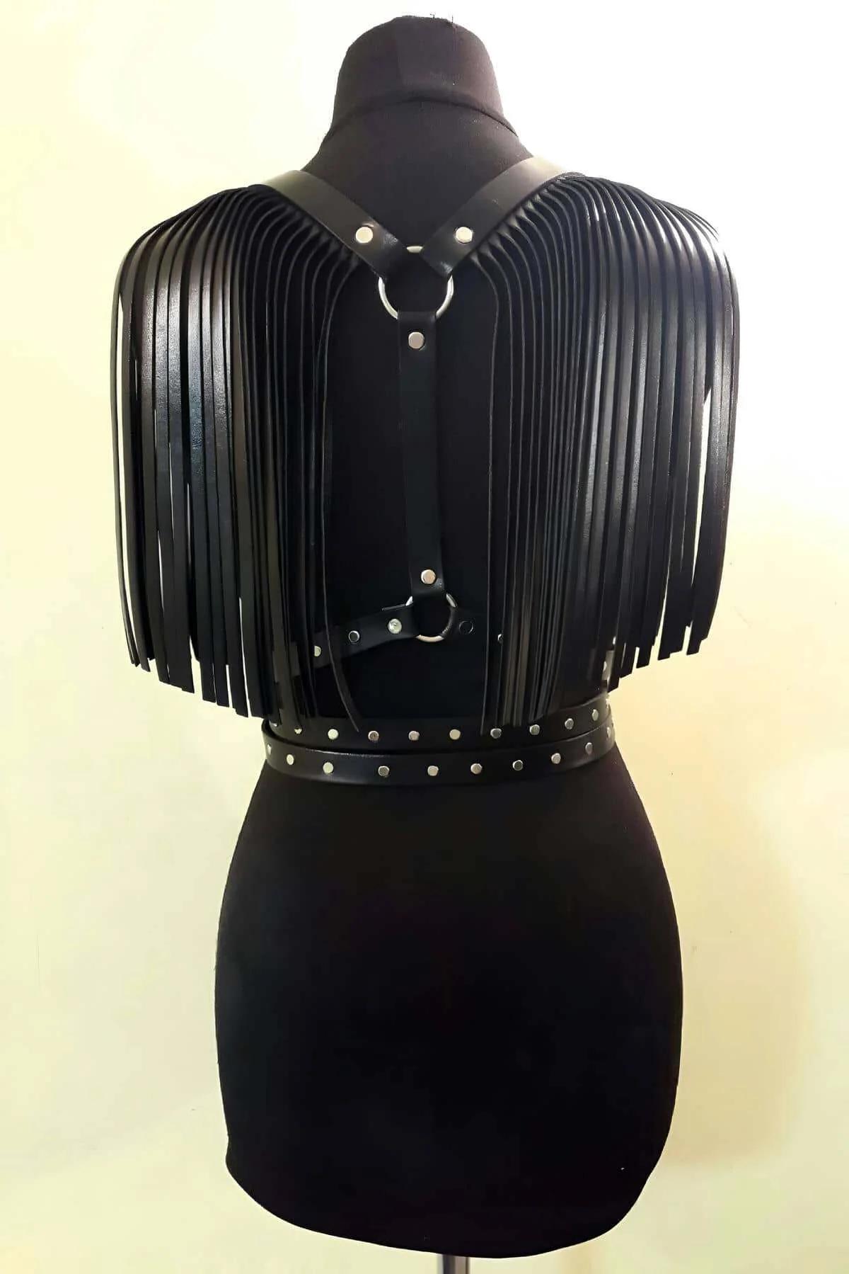 close-up of silver dome studs on double waist bands of black faux leather chest harness