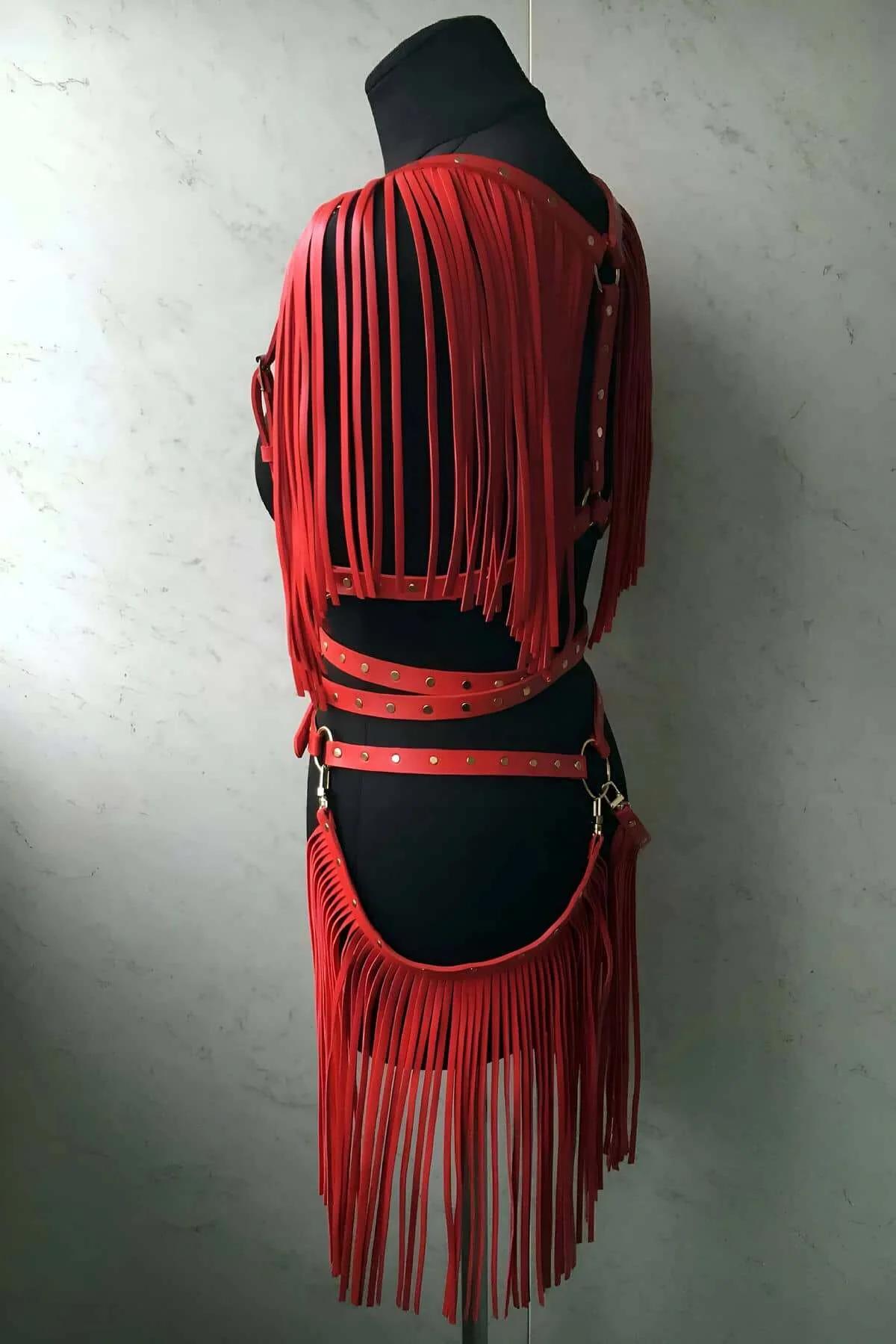 Front view of red fringe waist belt harness showing cascading hip fringe and D-ring clips