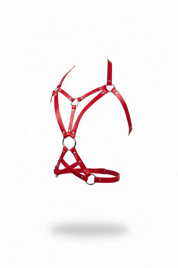 strappy red faux leather body harness with three silver O-rings and geometric cage strap pattern on white background