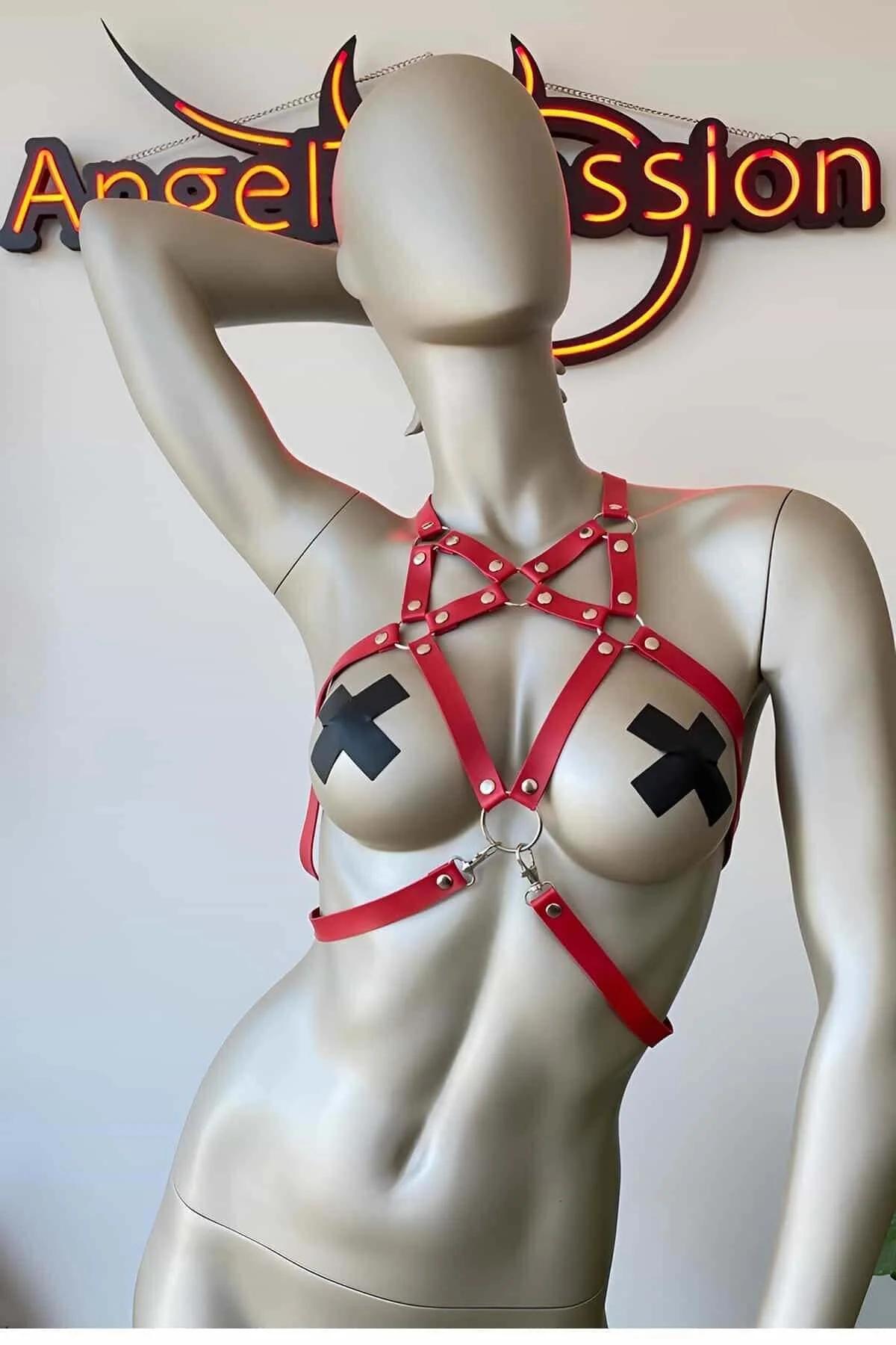 Close-up of black star rivets on red faux leather harness straps with silver-tone hardware