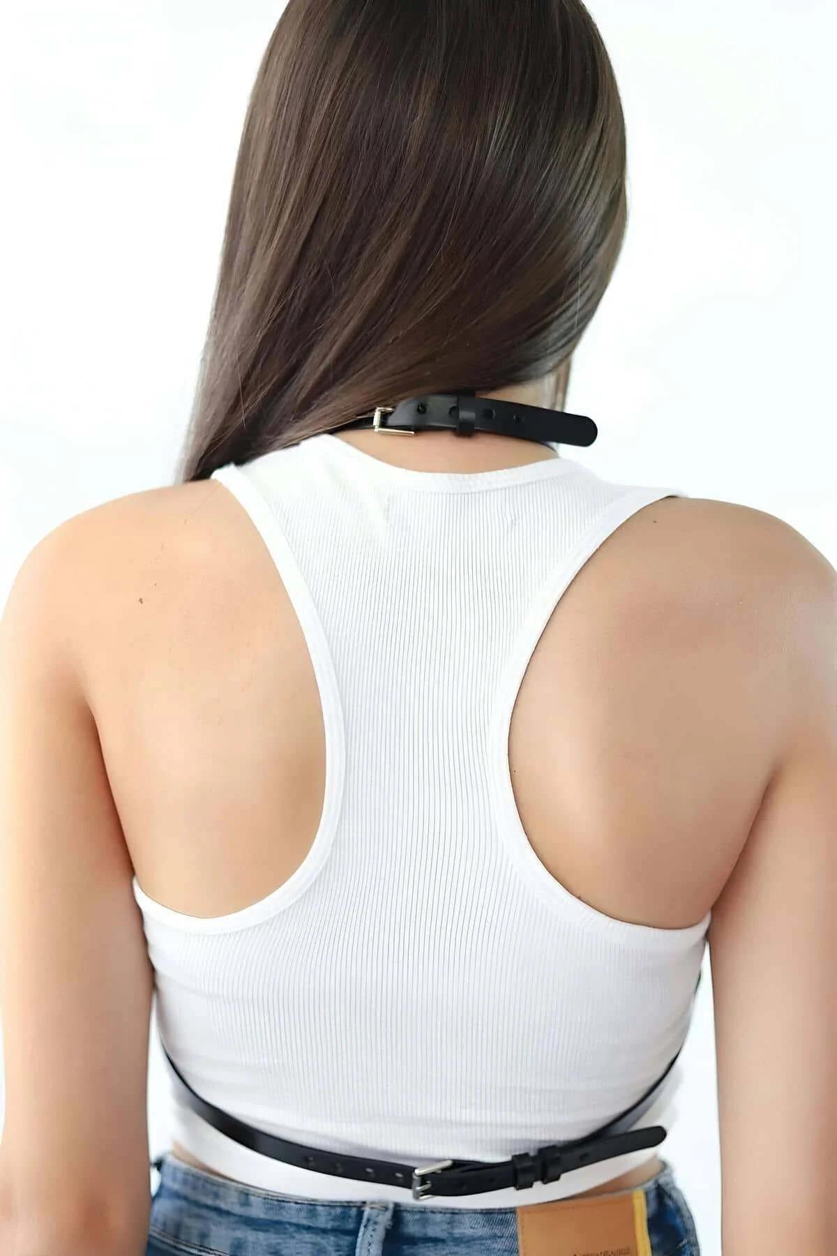 Black strappy body harness with cage strap silhouette and halter neck loop from front angle