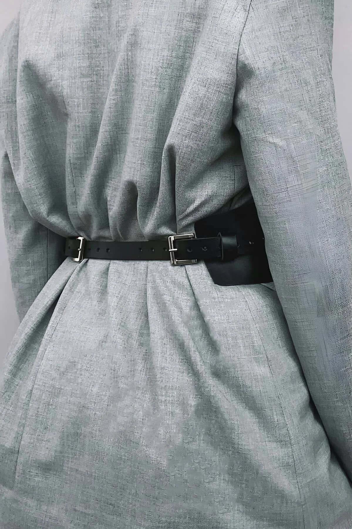 front close-up of black cincher belt showing silver metal eyelets and black lace-up cord detail