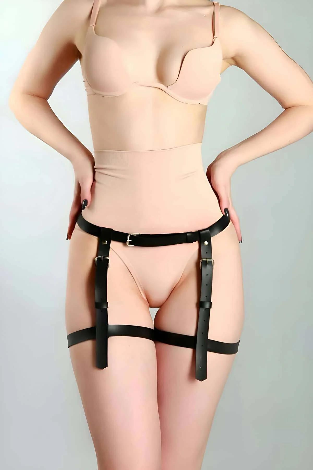 Close-up of gold-tone metal pin buckle on black faux leather garter strap