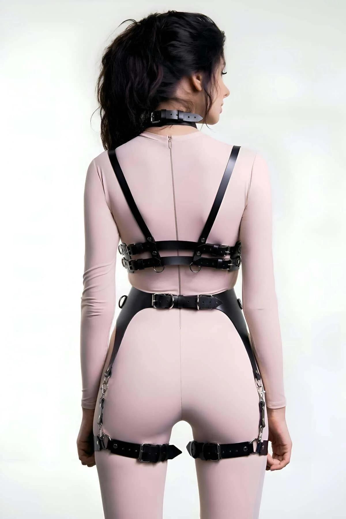 Black PU faux leather chest harness with central silver O-ring and adjustable pin buckle straps