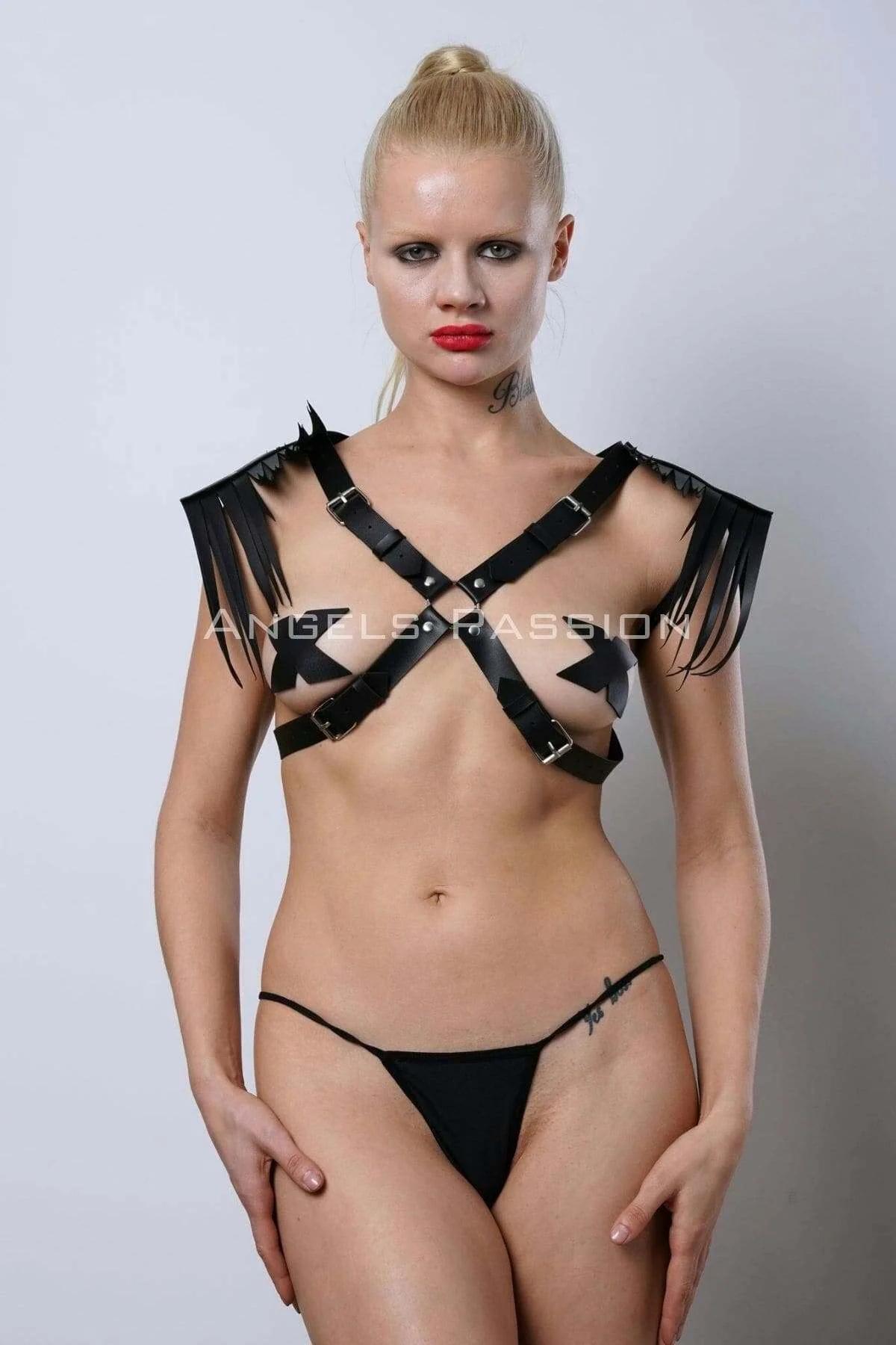 Cross-back strap detail of black faux leather fringe shoulder harness worn back view