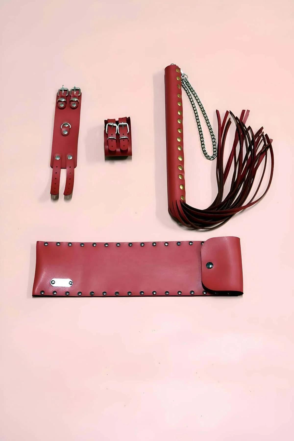 red faux leather whip and cuff fashion accessory set full layout overhead view