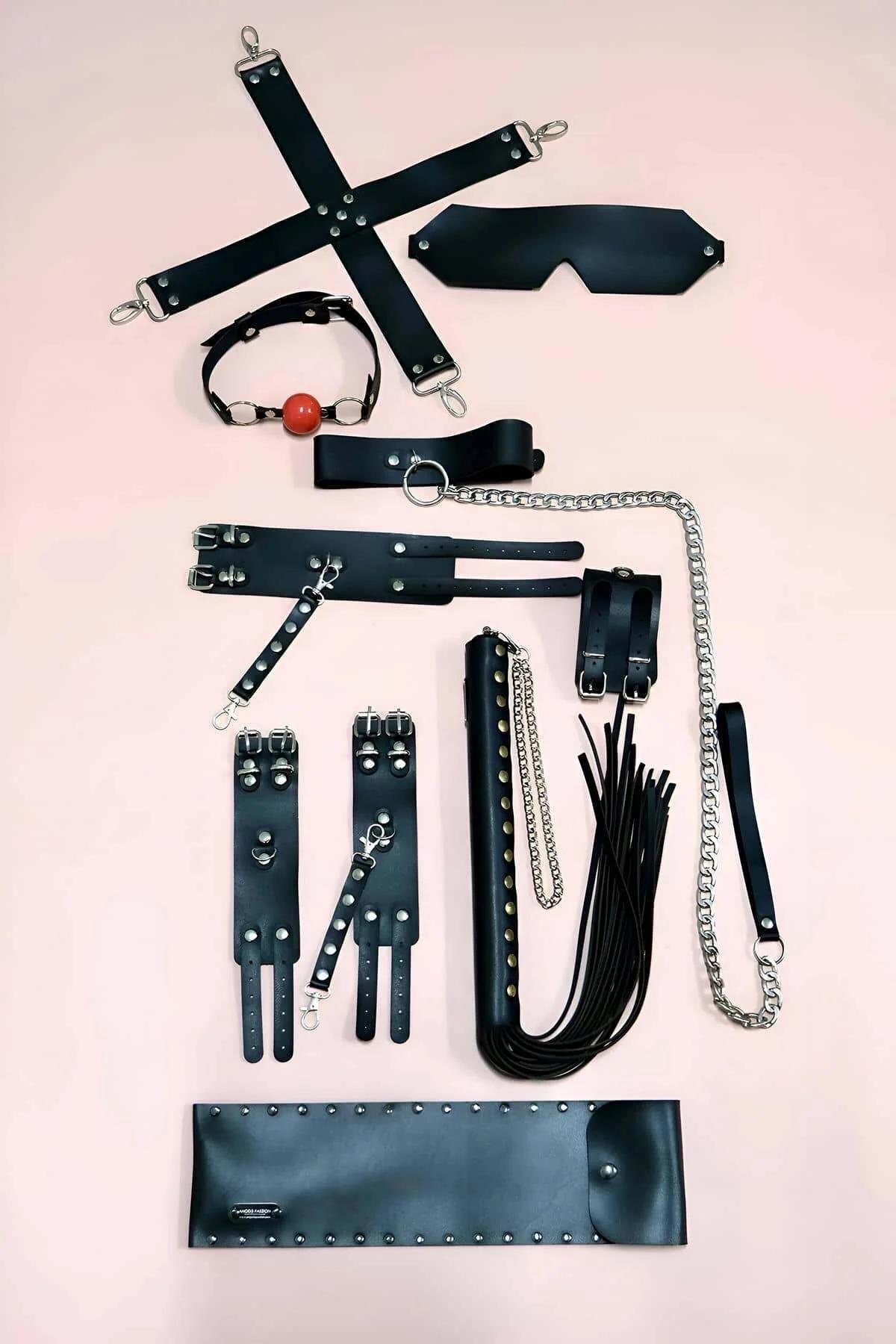 Black faux leather double-buckle wrist and ankle cuffs with silver snap hooks, approx. 6 cm wide