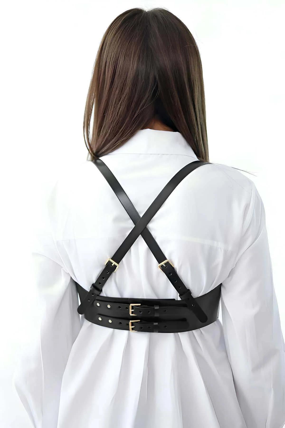 adjustable shoulder straps of black faux leather corset harness showing gold-toned zinc alloy hardware detail