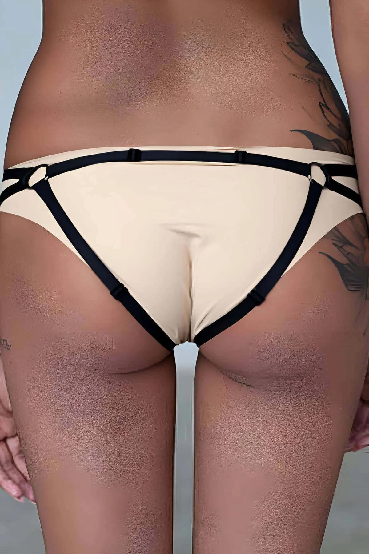 front view cream body harness showing gold O-ring hardware at center chest and black binding straps