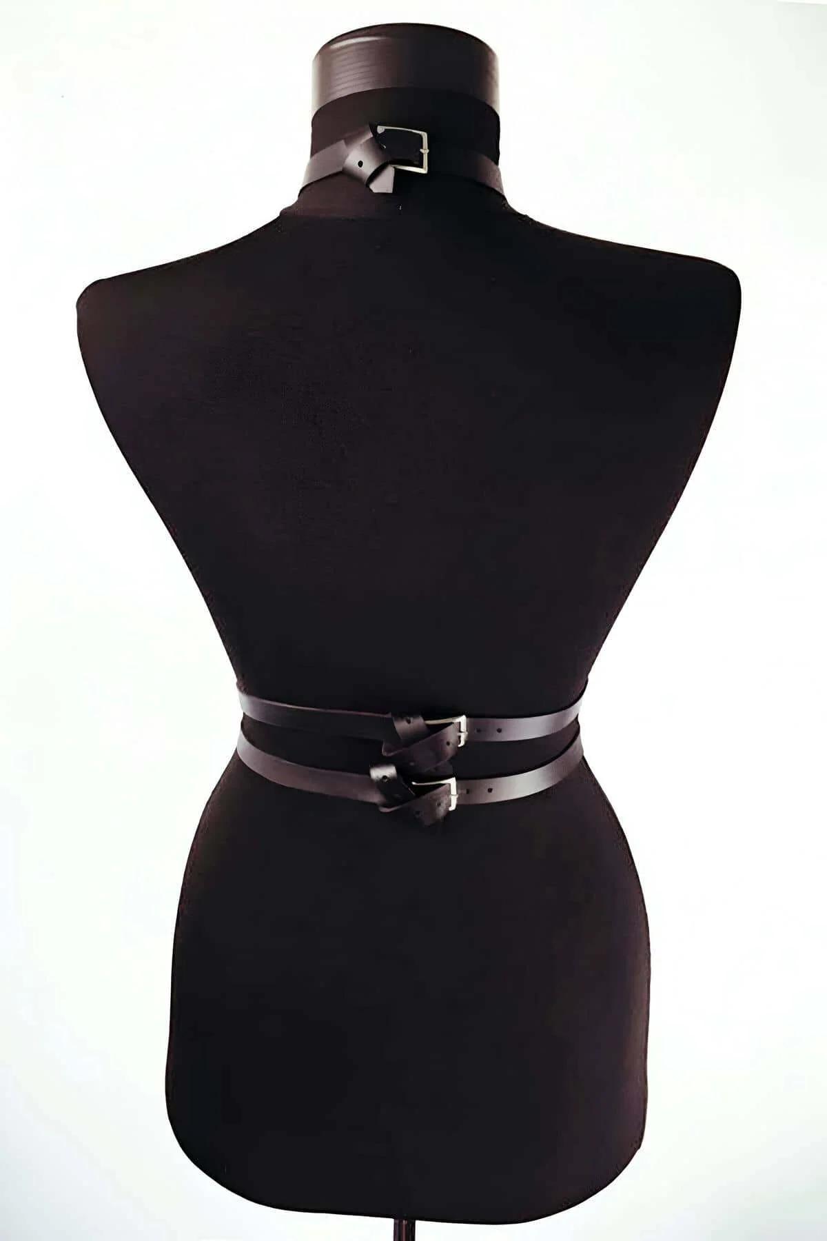 Black leather chest harness collar and vertical strap detail on dark mannequin