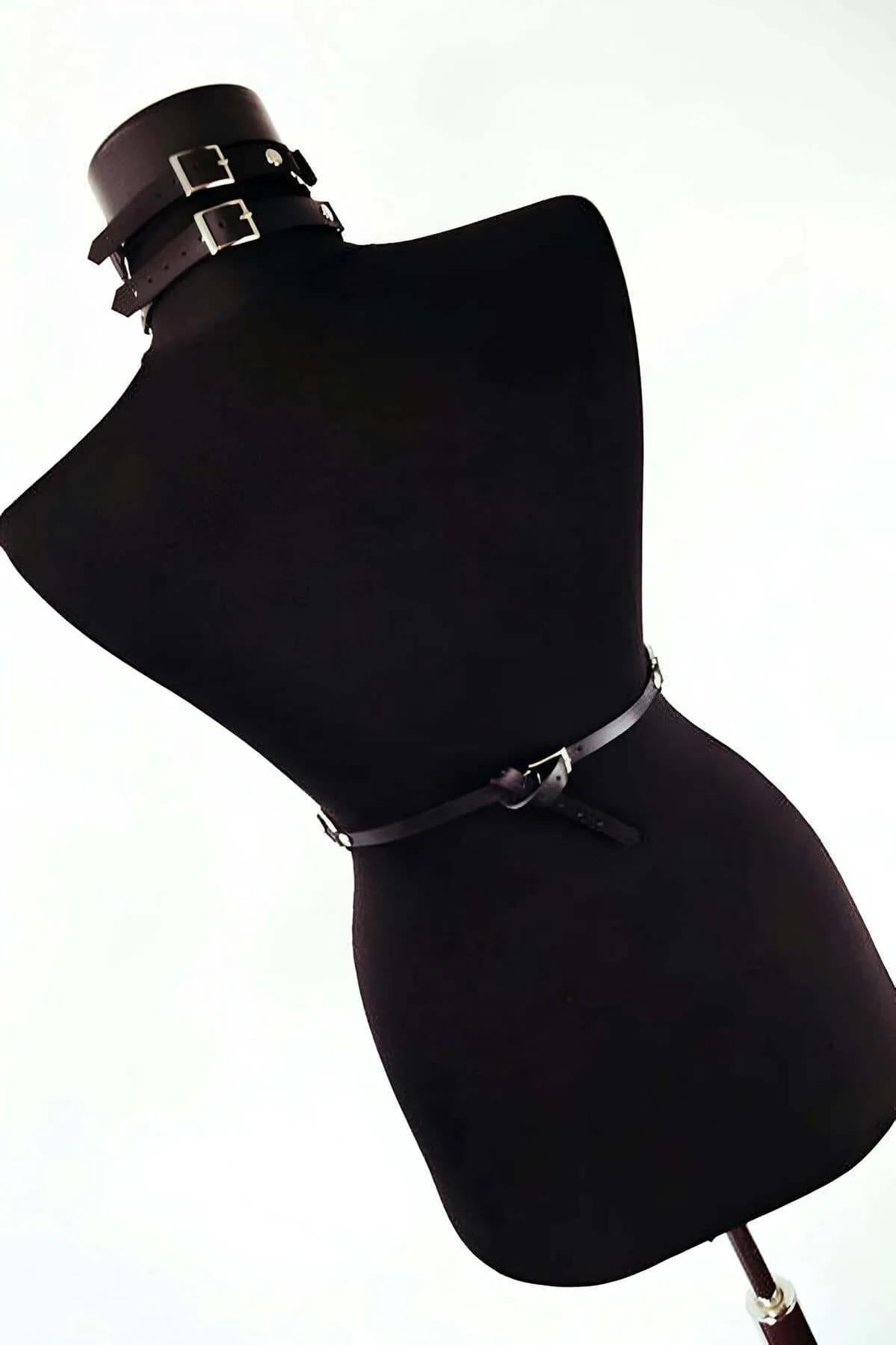 Faux leather choker collar with metal snap closure and chest O-ring connection, close-up