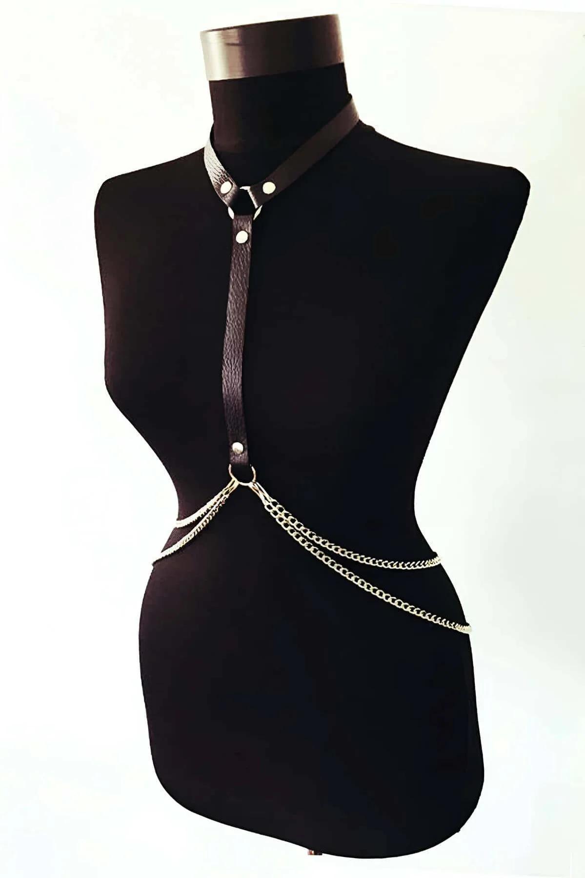 Close-up of silver O-ring and stud rivets on black PU faux leather vertical chest band