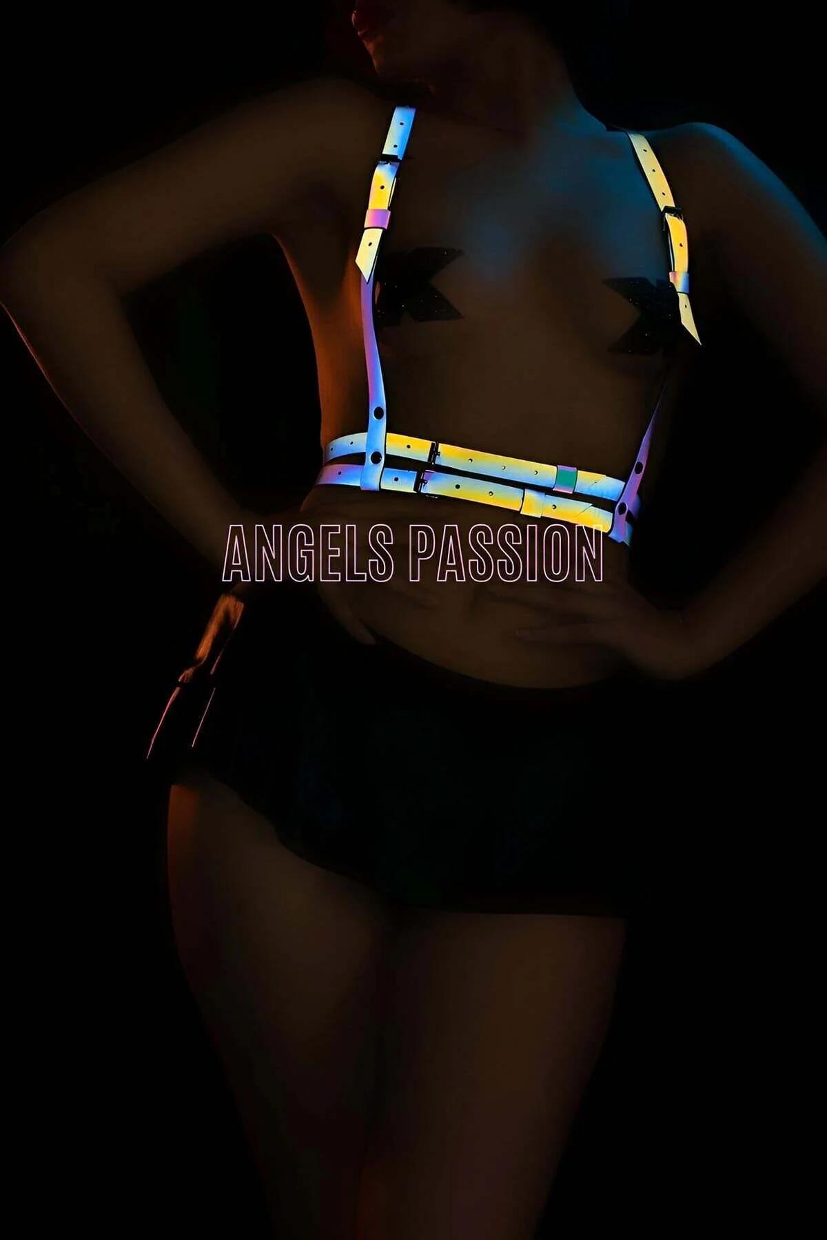 Close-up of segmented reflective panels on rainbow body harness shifting yellow and blue under direct light