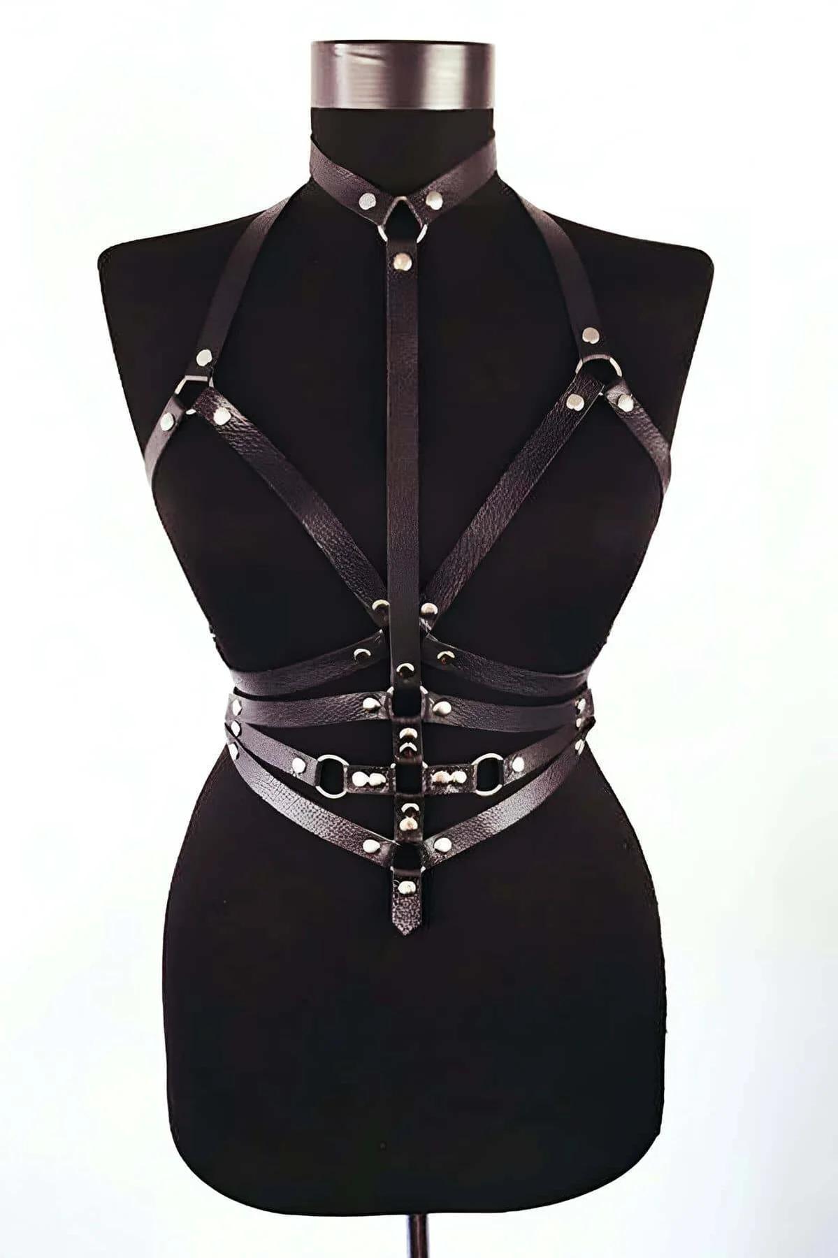 Black full body harness with O-ring hardware styled over bare skin with mini skirt