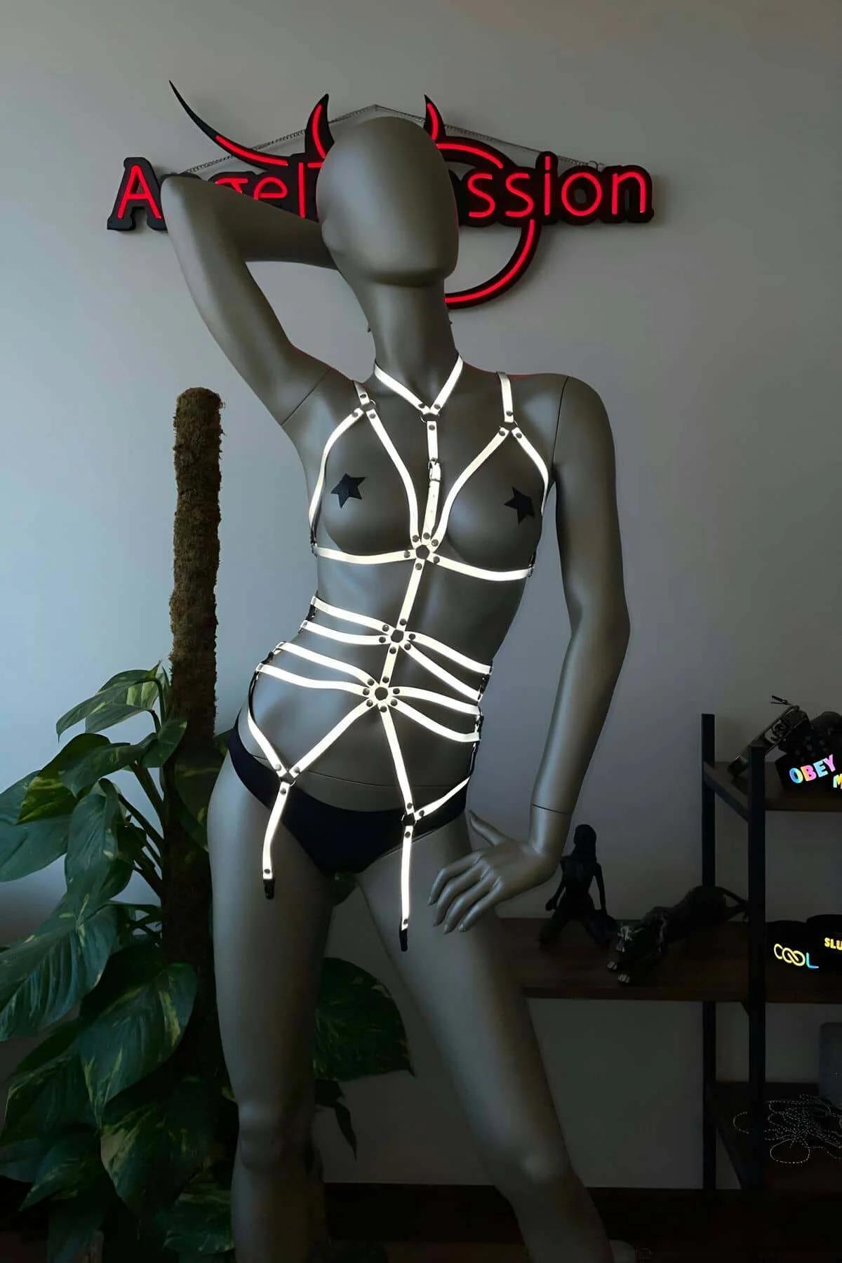Front view of adjustable black harness with horizontal waist bands and reflective tape detail