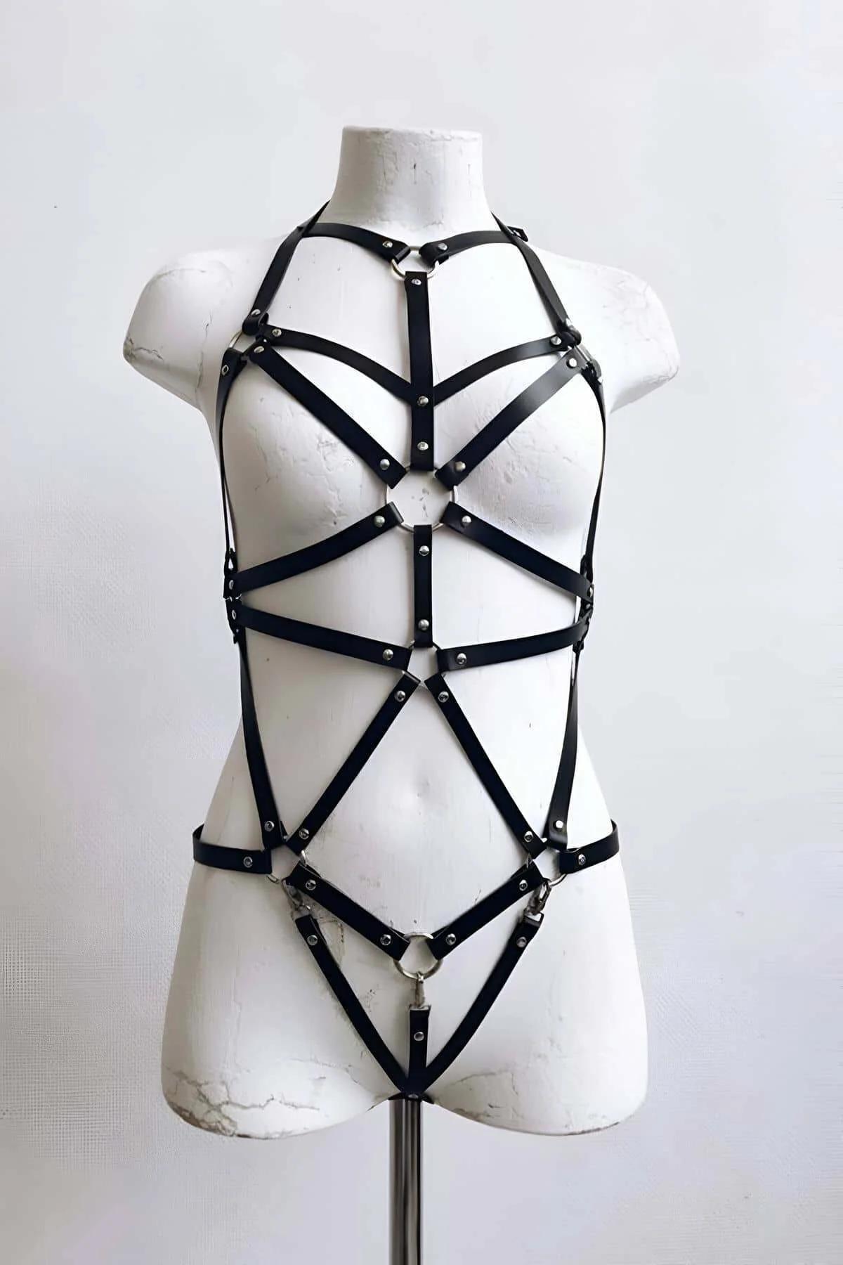 Front view of black PU leather cage harness showing diagonal V-strap pattern from halter neck to mid-torso