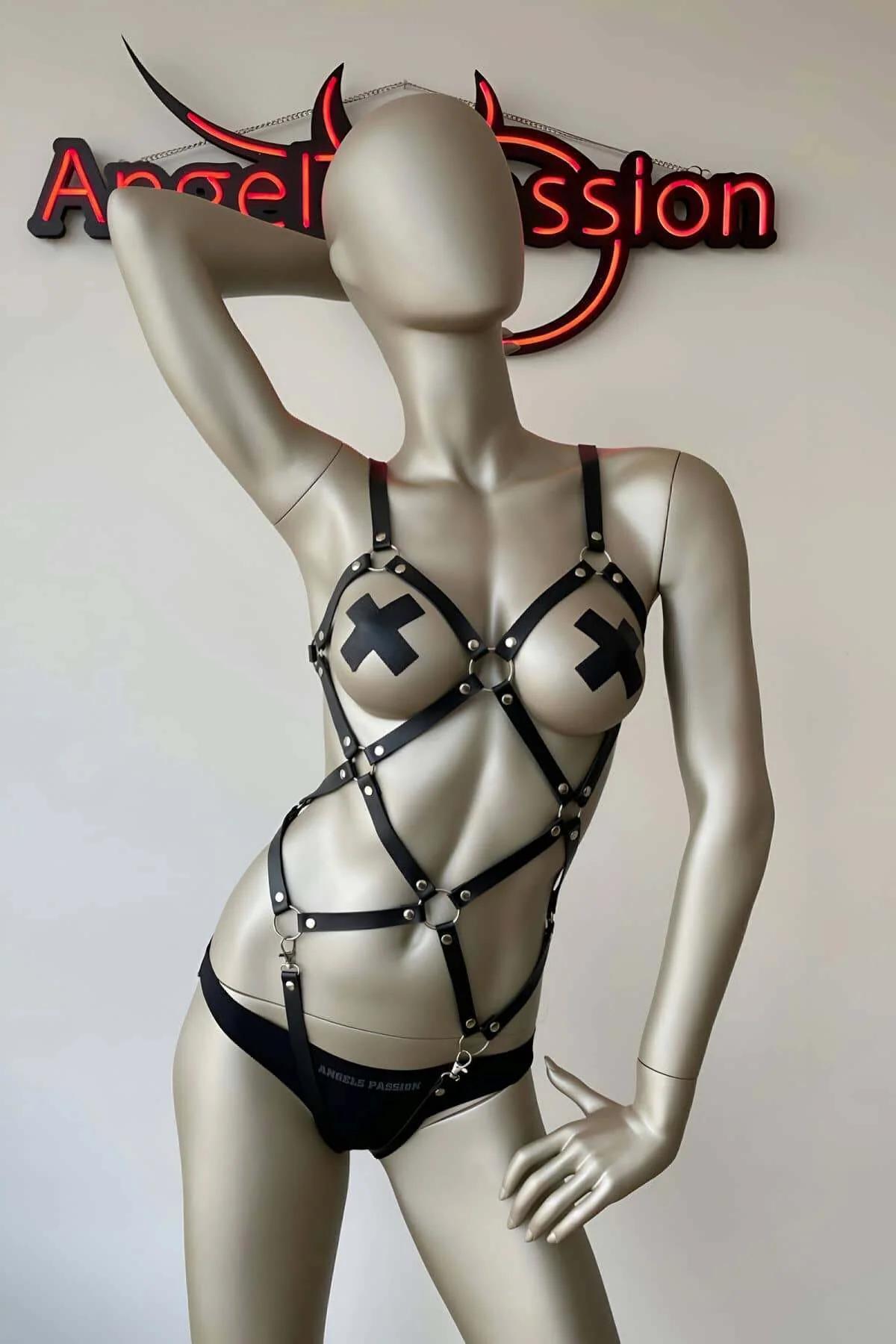 front view of black PU leather cage harness showing X-pattern chest straps and adjustable buckle closures
