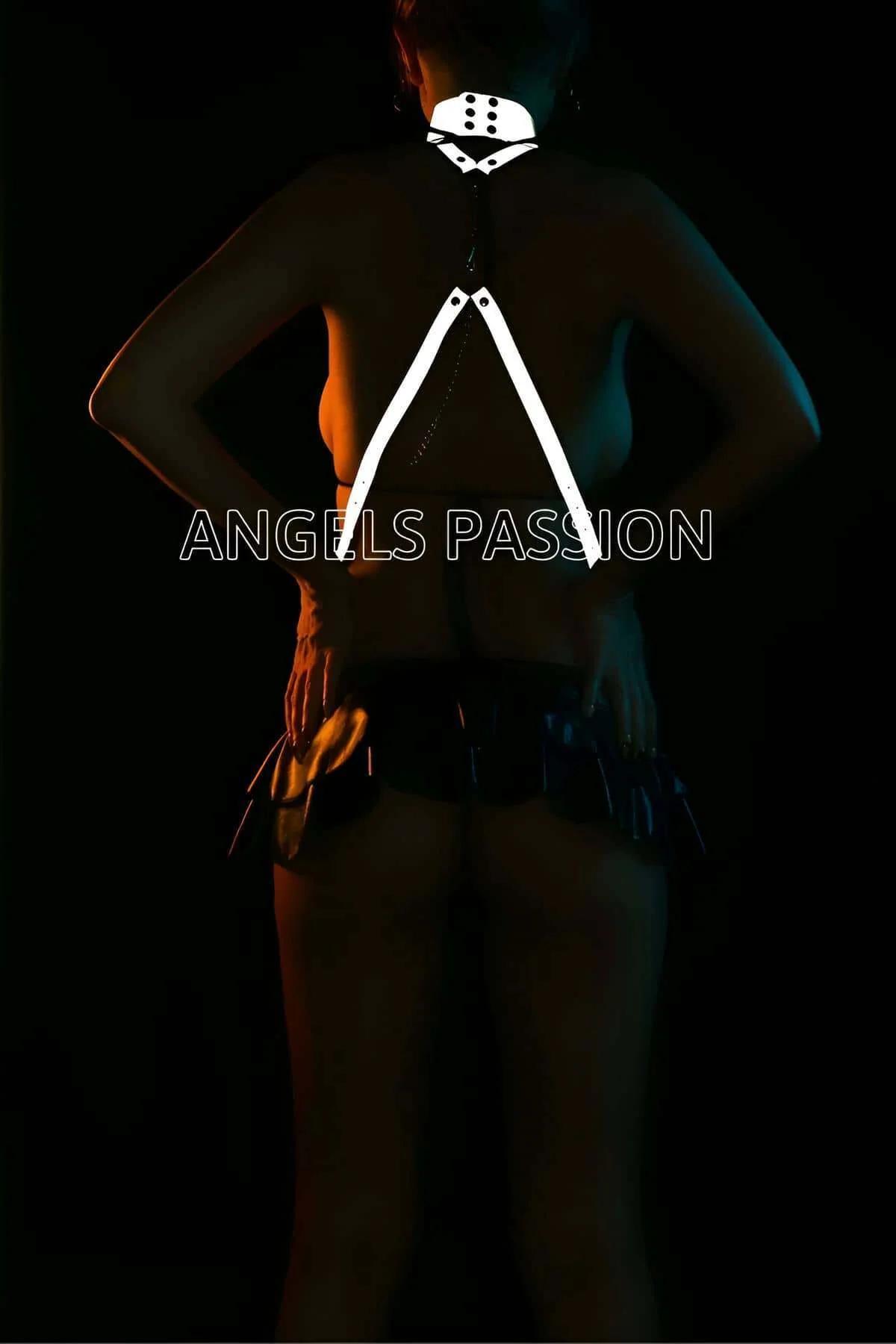 Reflective cross-body harness showing diagonal strap placement across torso under teal stage lighting