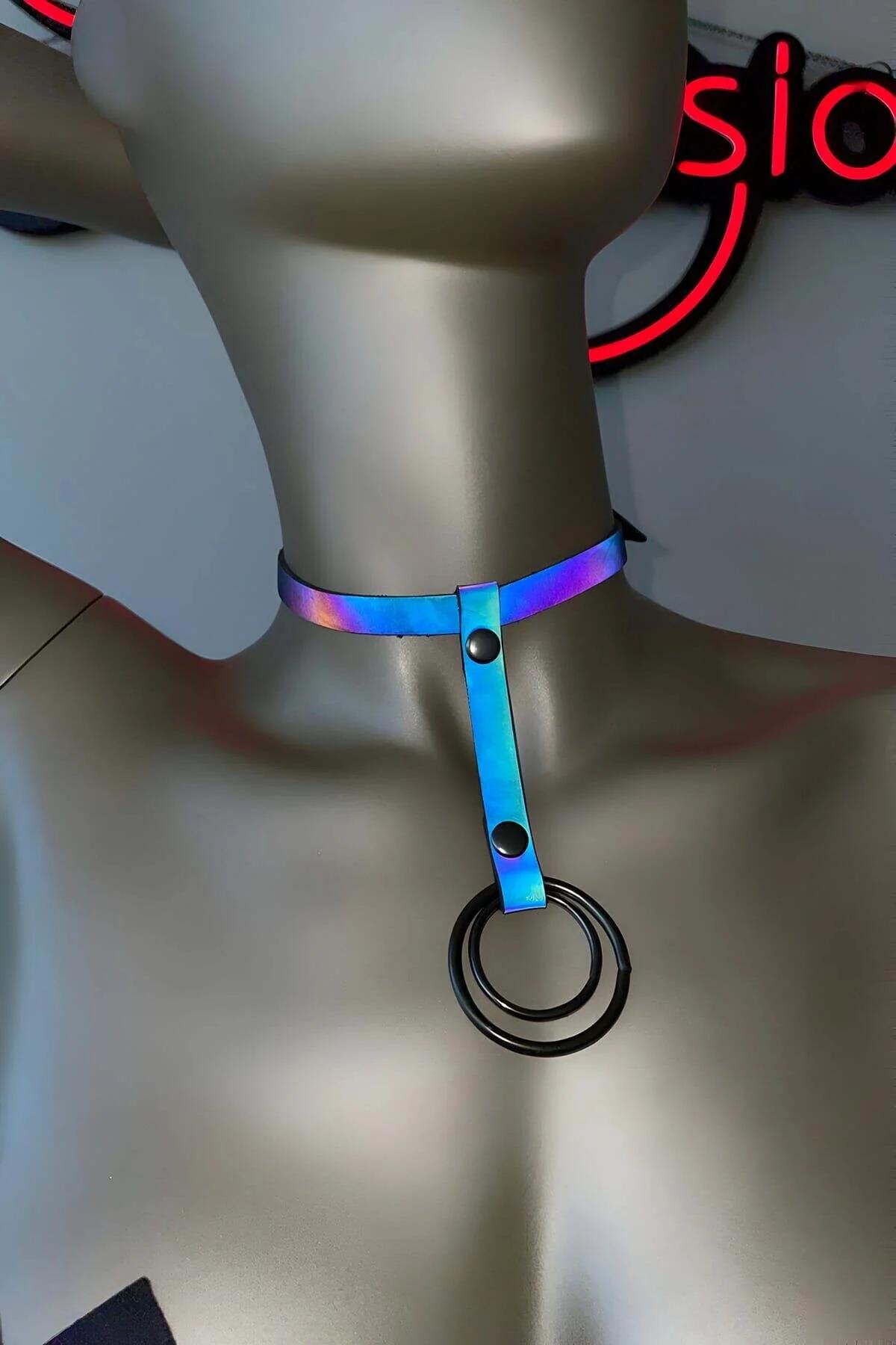 Reflective choker harness worn over black outfit showing drop O-ring at sternum