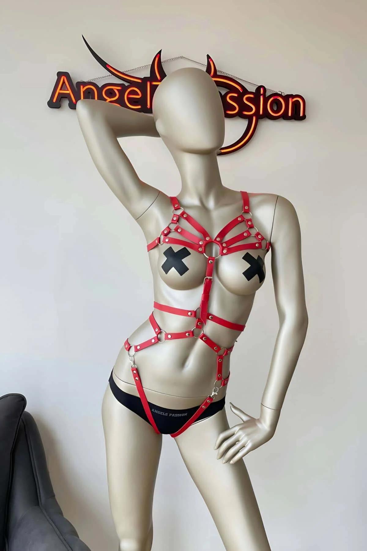 Front view of ruby red PU leather chest cage harness with gold-tone rivet hardware and center O-ring
