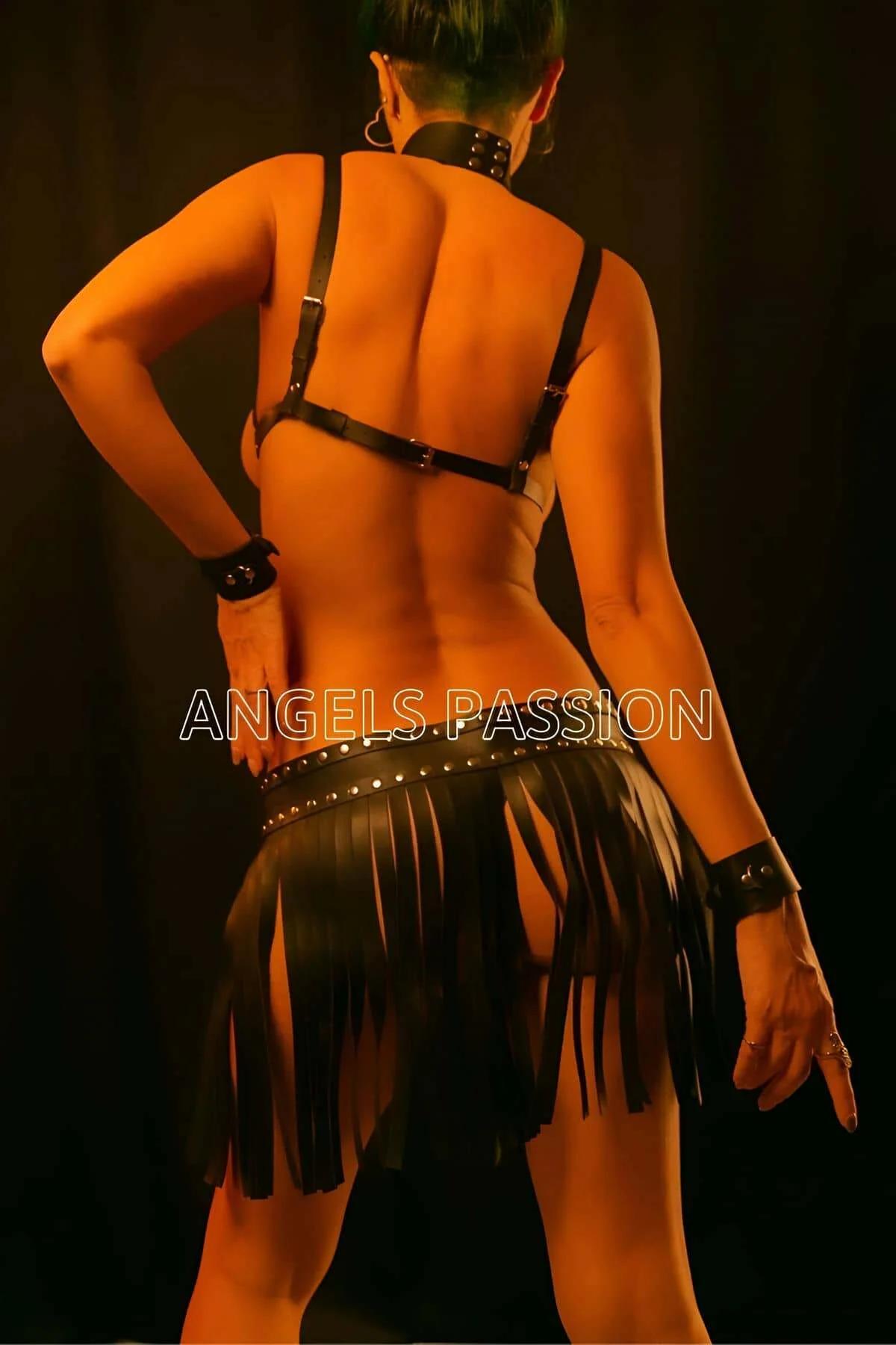 Silver-tone studded waistband on black faux leather fringe skirt, double-buckle closure