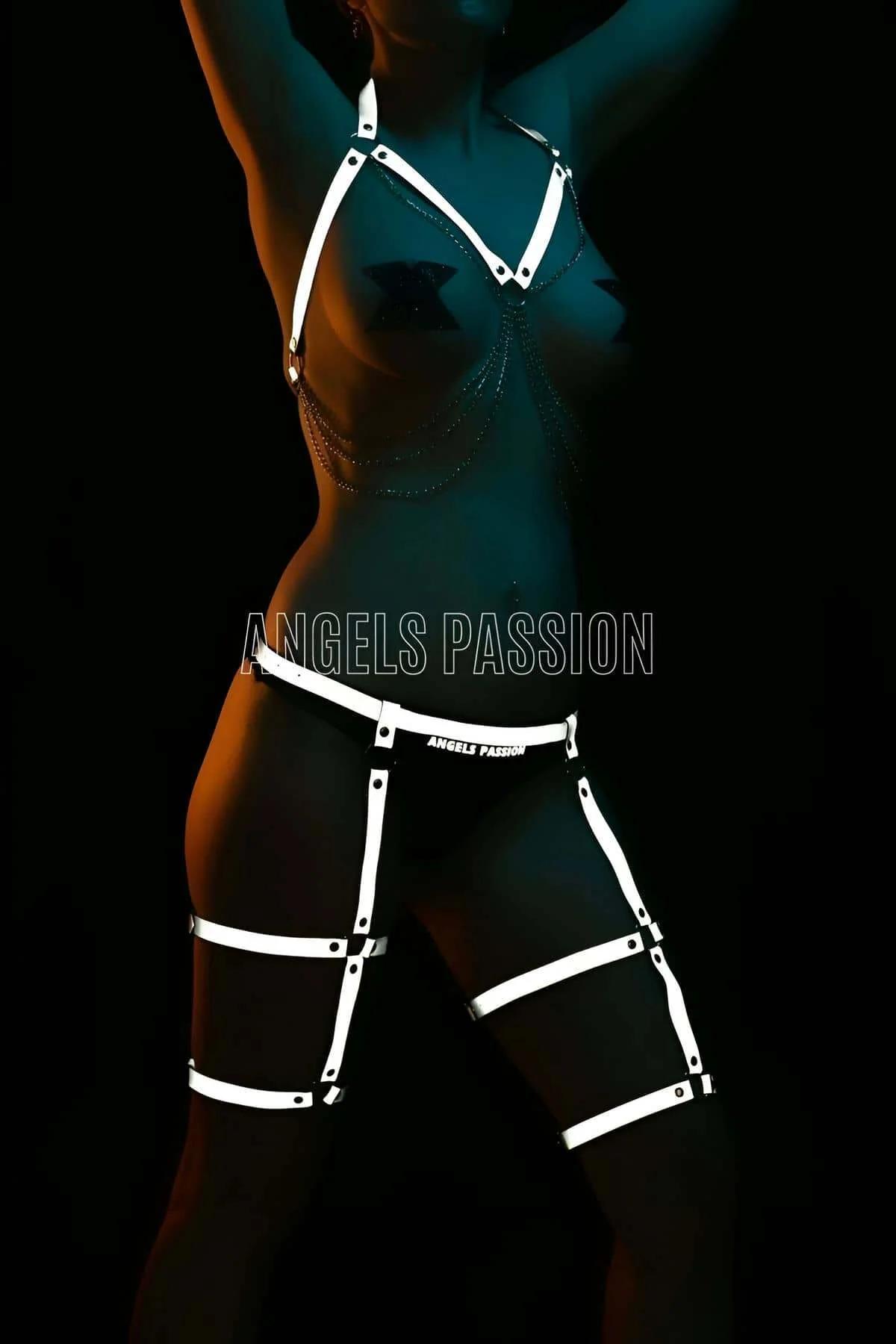 Close-up of reflective ribbon strip and zinc-alloy rivet hardware on black elastic harness strap
