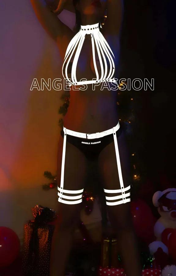 Reflective white multi-strap cage halter harness and garter set with triple thigh bands worn in dark festival setting