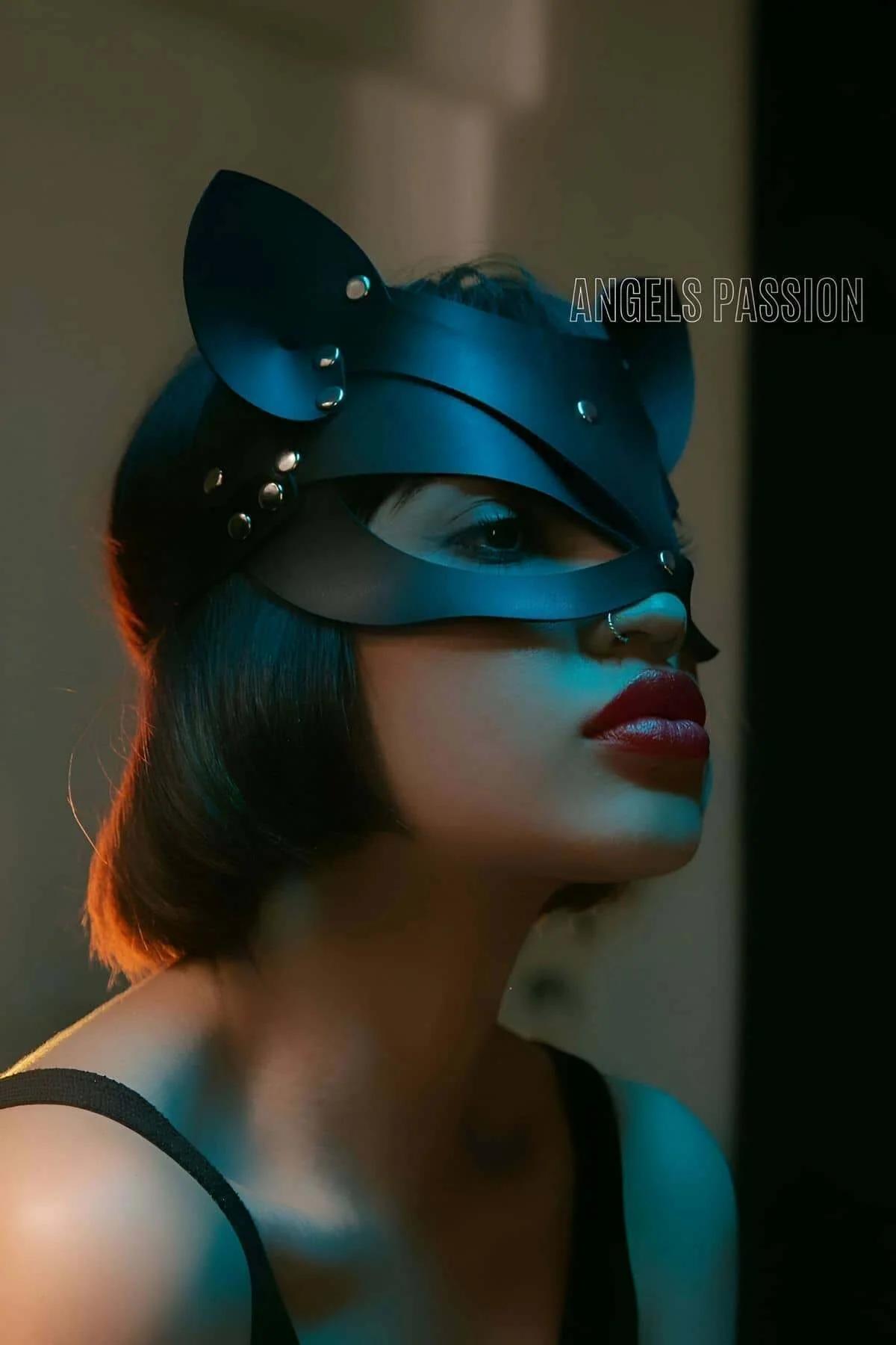 Black PU cat mask front view showing two silver stud rivets at forehead bridge and ear bases