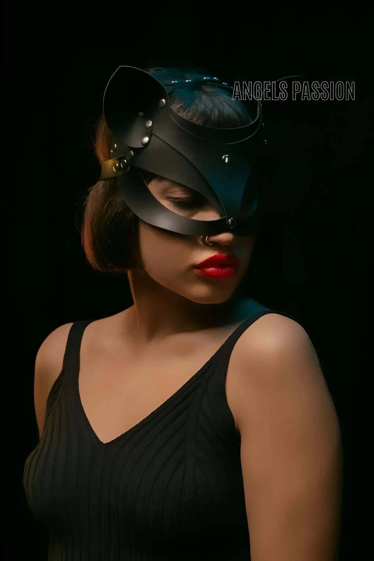 Black faux leather half-face cat mask side angle revealing gold-tone pin-buckle strap hardware