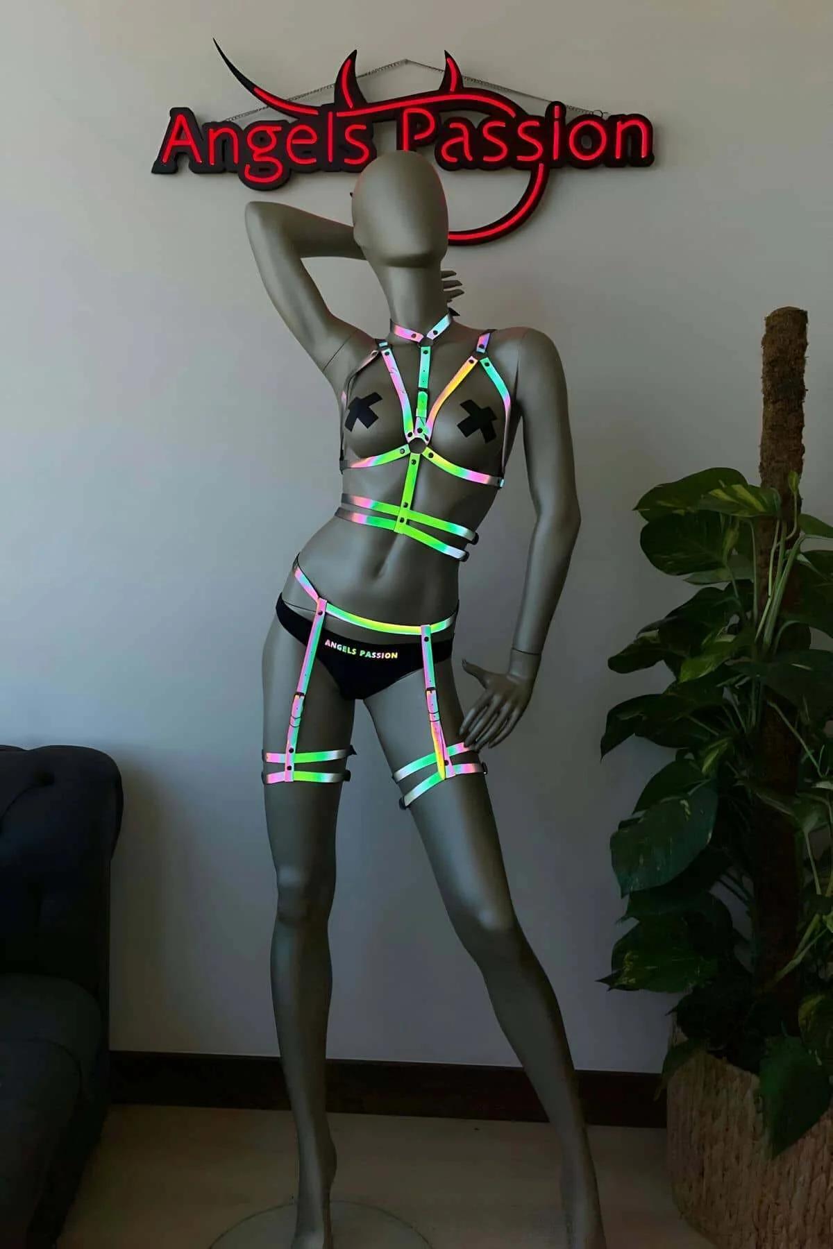 Hip band and double-strap leg garters from reflective rainbow harness set under colored stage lighting