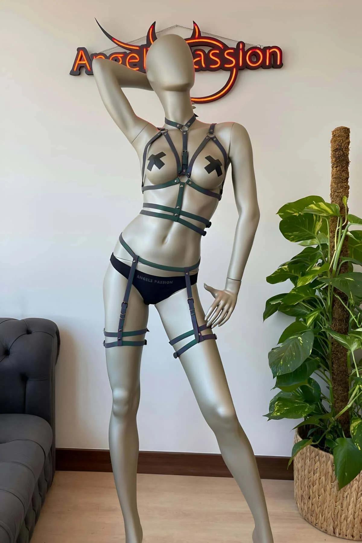 Full-length view of rainbow iridescent harness set with chest straps and thigh garters on dark background