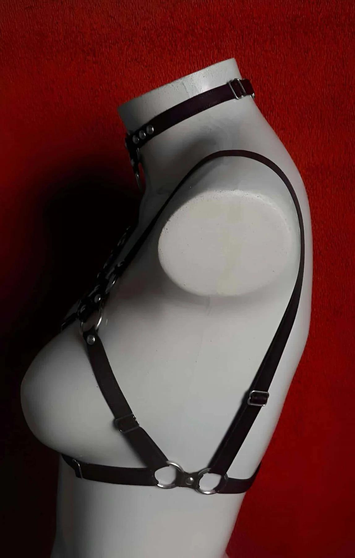 full torso view of geometric black strap chest cage harness over bare skin