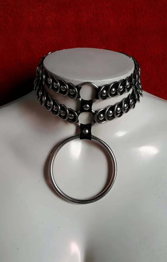 Black two-row linked-ring choker with large silver O-ring pendant on mannequin, faux leather base with dome rivets