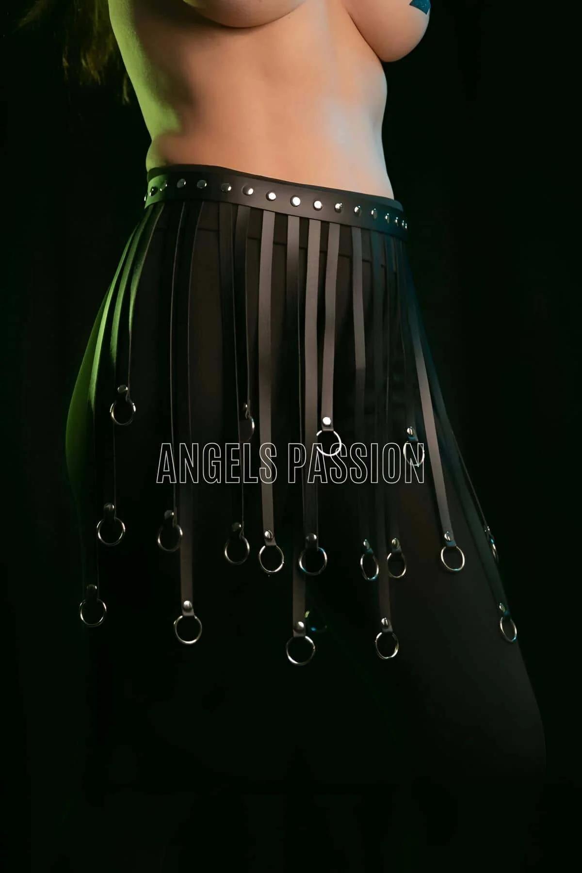 Side view of black faux leather fringe skirt showing strap movement and O-ring hem