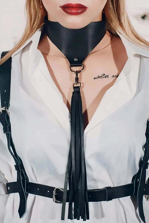 Black vegan leather choker harness with D-ring swivel tassel and silver buckle belt worn over white shirt