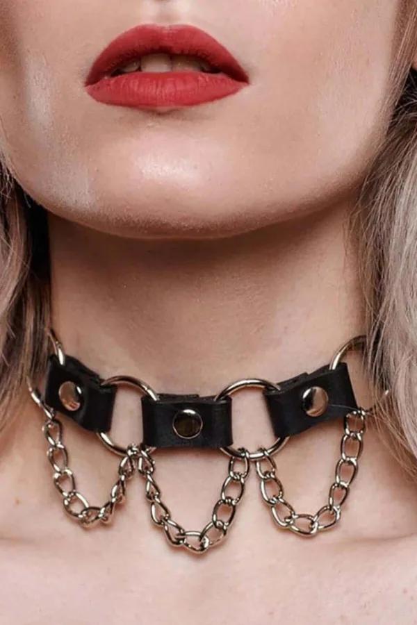 Black faux leather choker necklace with two gold O-rings and draped gold cable chain loops on neck