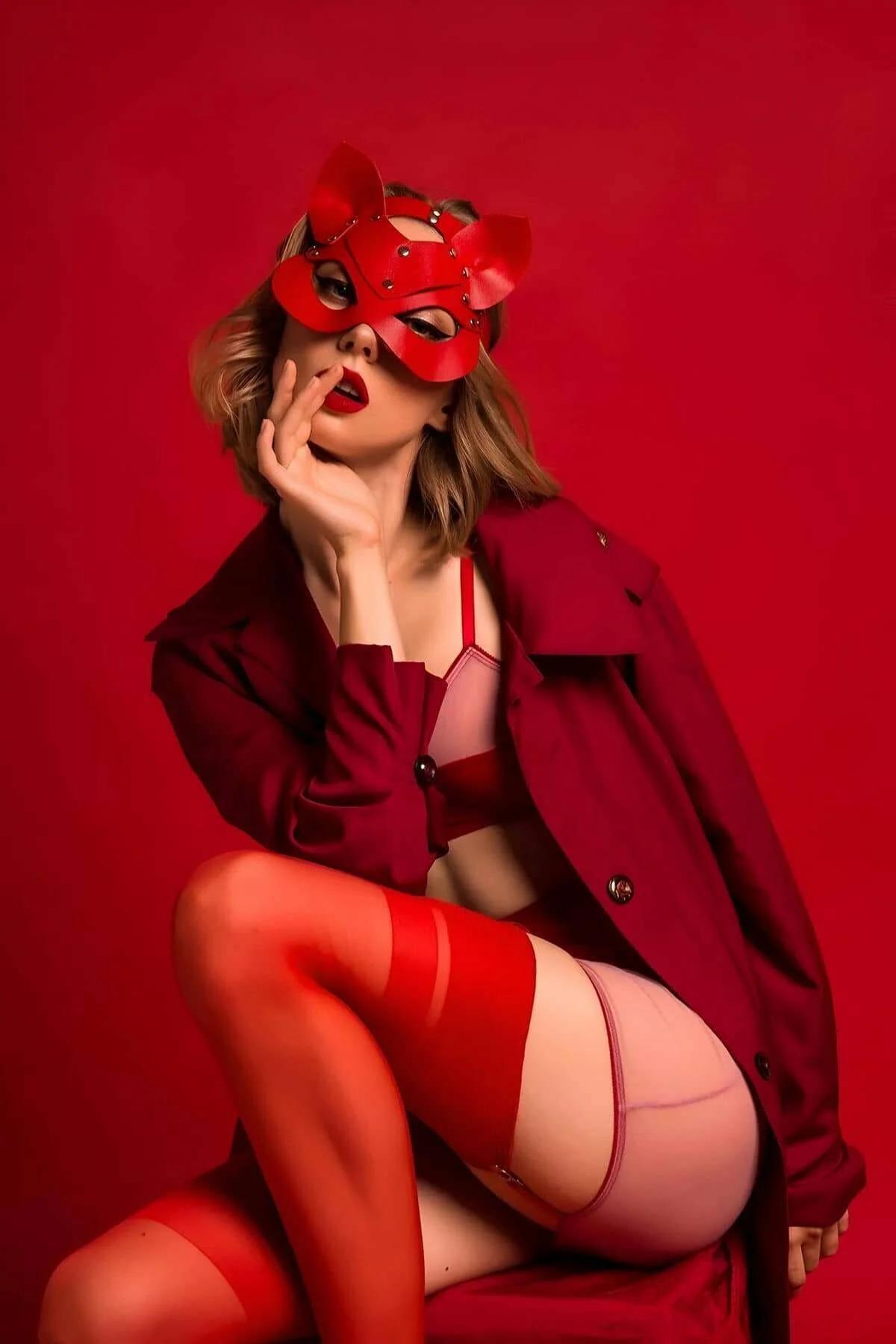 Close-up of silver crystal studs on red PU faux leather cat ear mask panels