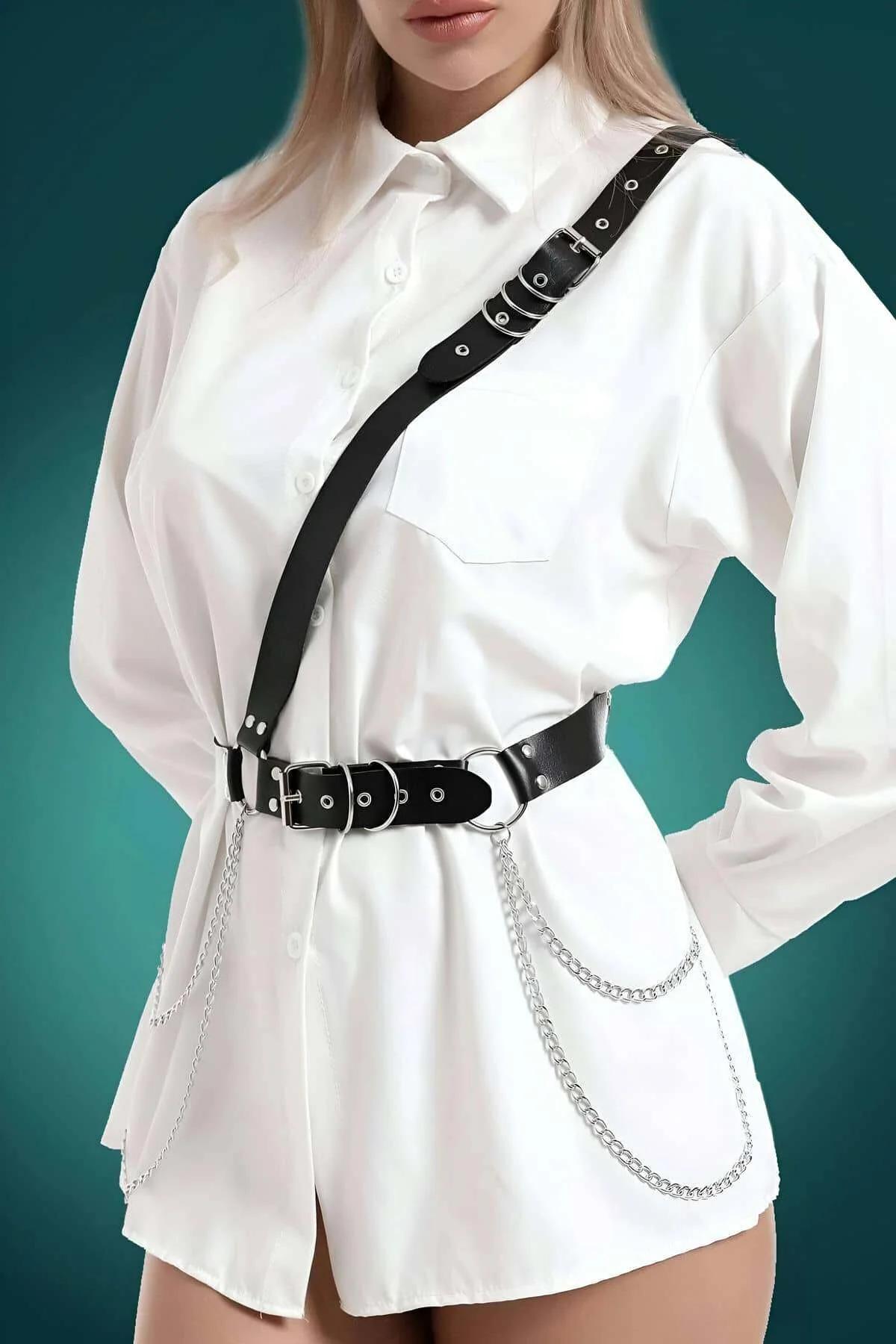 Diagonal black faux leather chest strap with silver buckle hardware detail