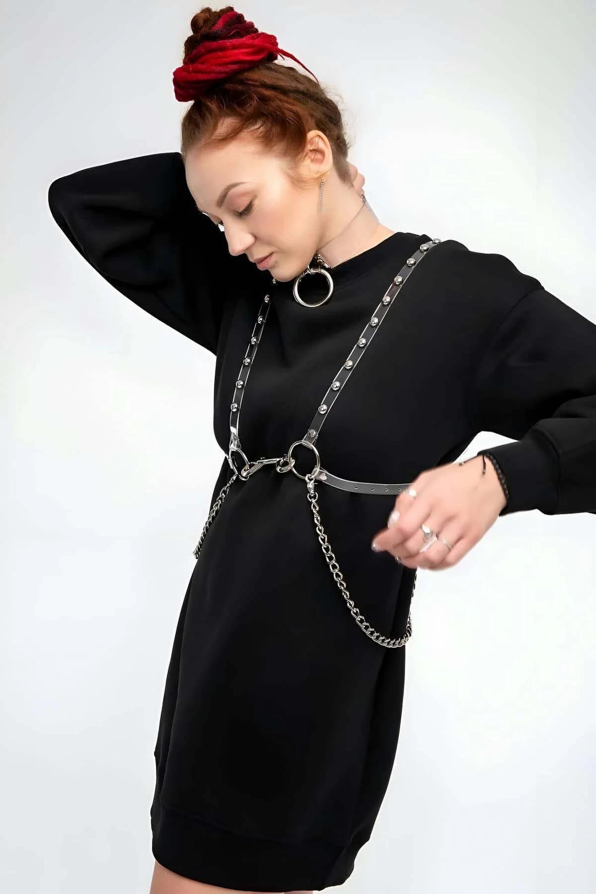 Detachable steel link chains hanging from waist band of transparent studded harness