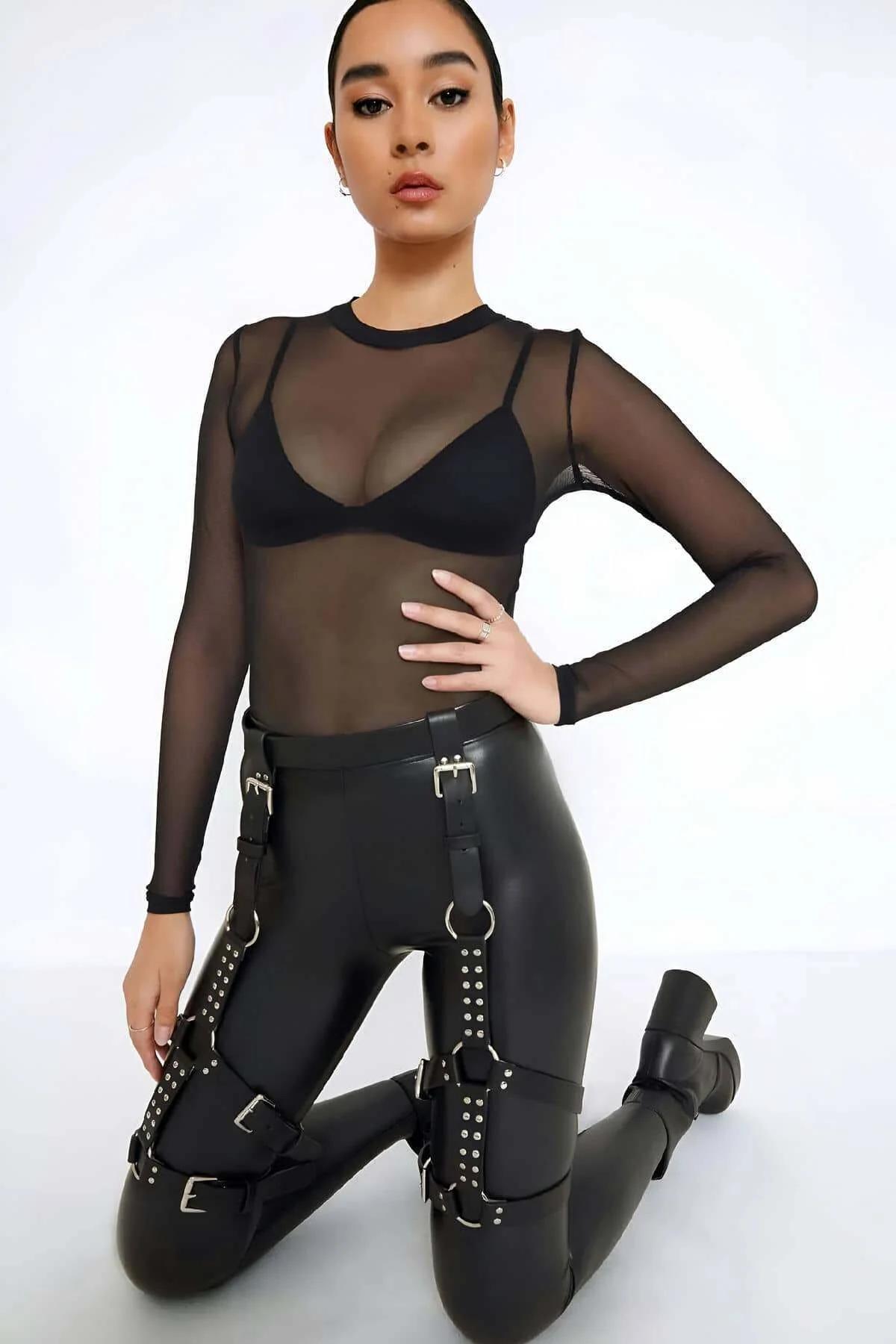 Black faux leather thigh harness laid flat showing full adjustable strap configuration and silver hardware
