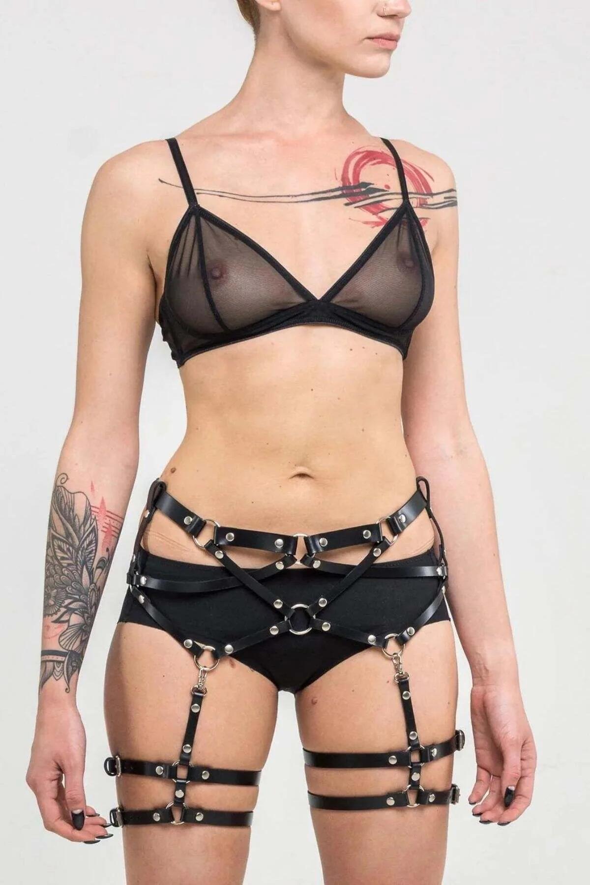 back view of black multi-strap thigh harness showing diagonal cross-straps and D-ring hardware