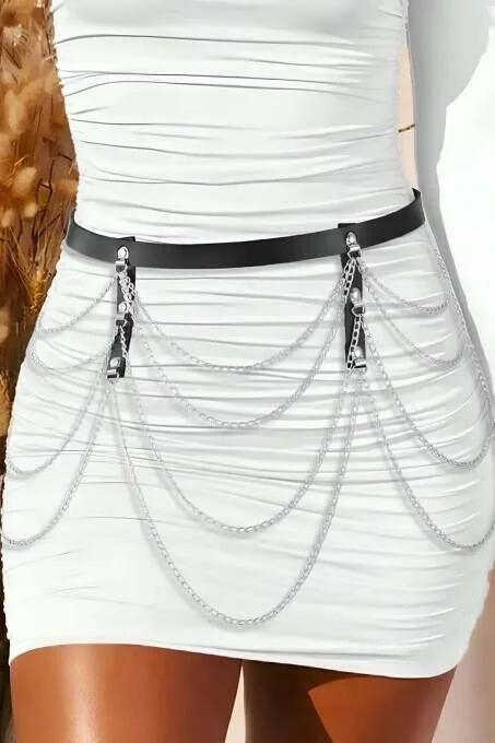 Slim 2 cm black PU leather waist belt with cascading silver-tone chain swags on white bodycon mini dress
