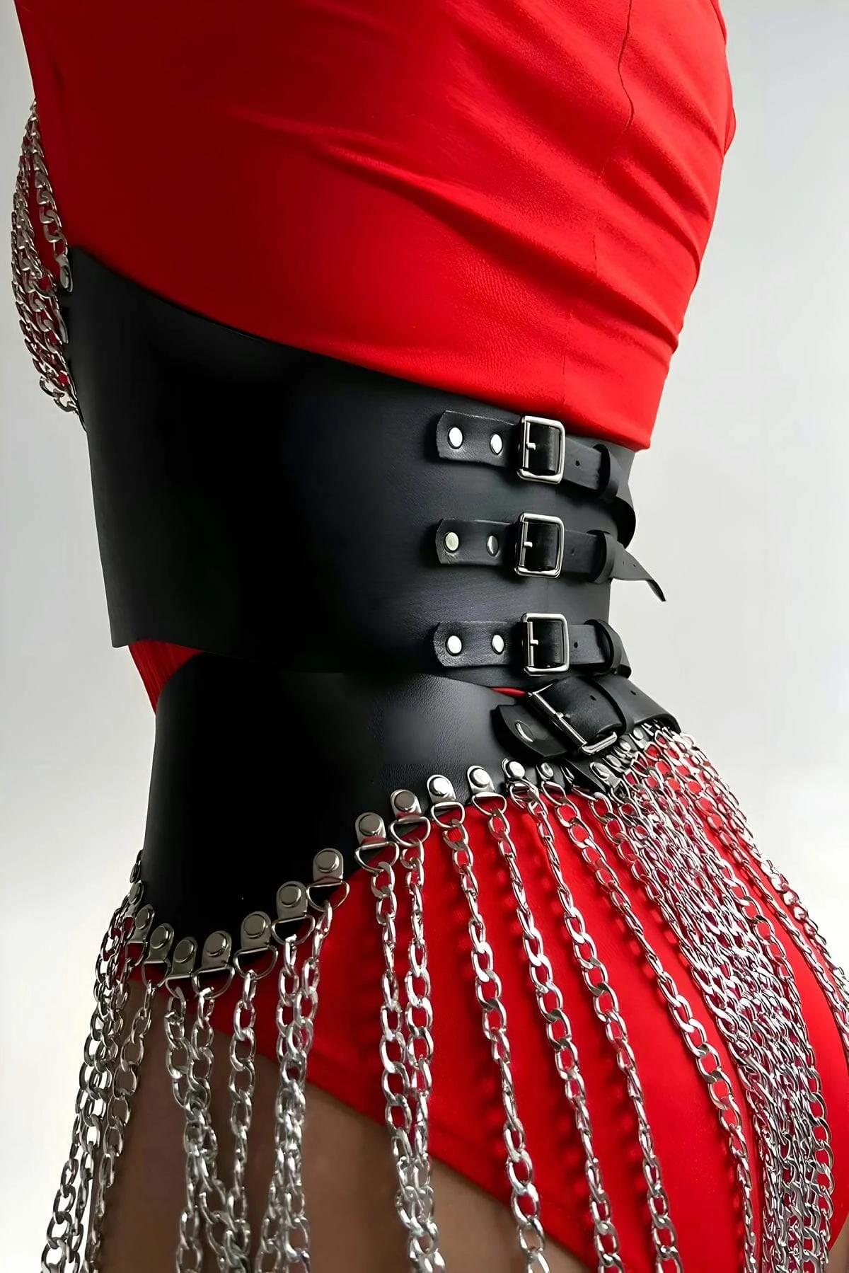 Full two-piece set flat lay: black PU leather bustier and matching chain hip panel with silver hardware