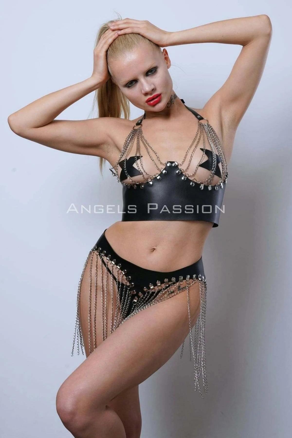 close-up of silver link chain fringe draping from black faux leather skirt waistband with ball stud rivets