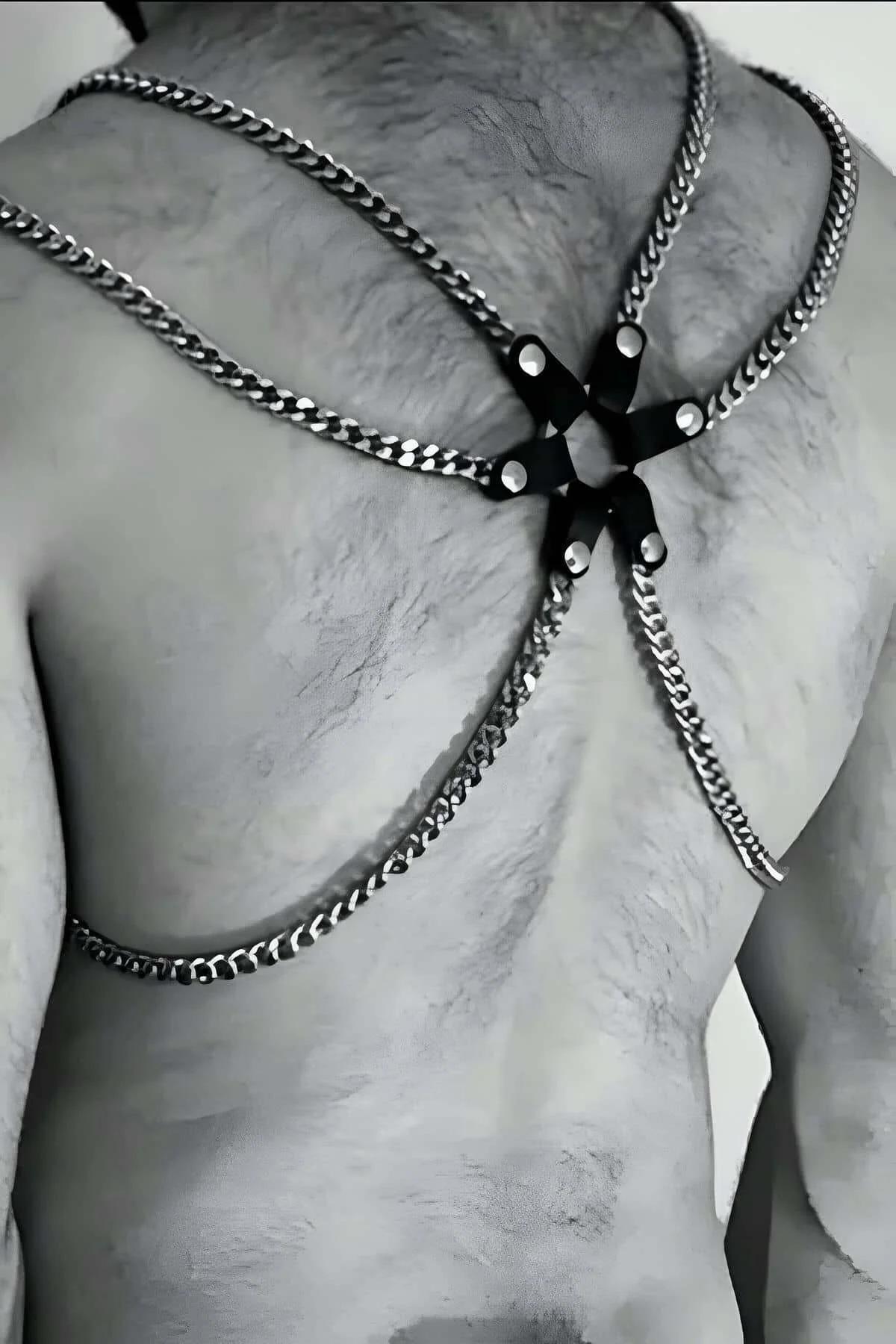 close-up of silver curb-link chains and black PU connector tabs on mens chest harness