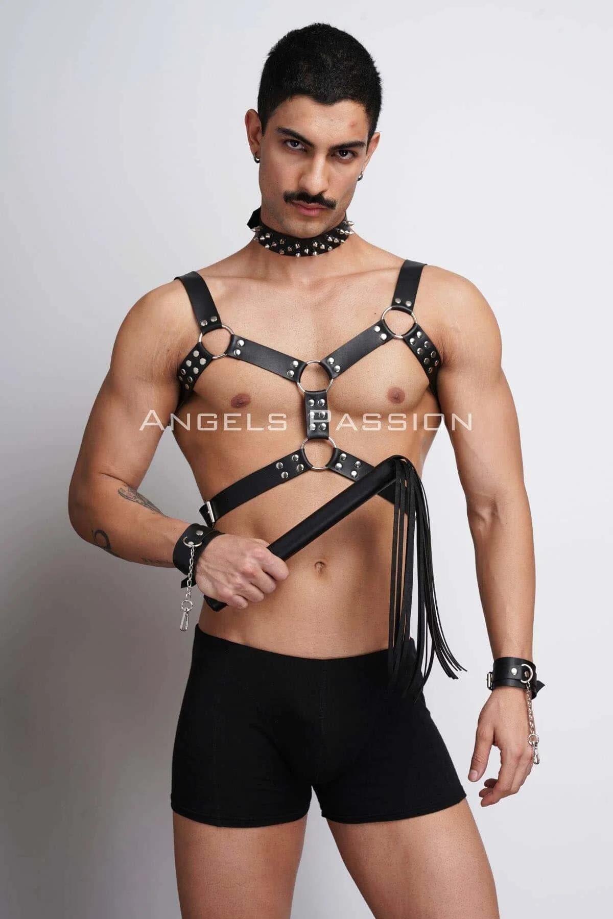 Detail of three silver O-ring junctions on black faux leather chest harness straps